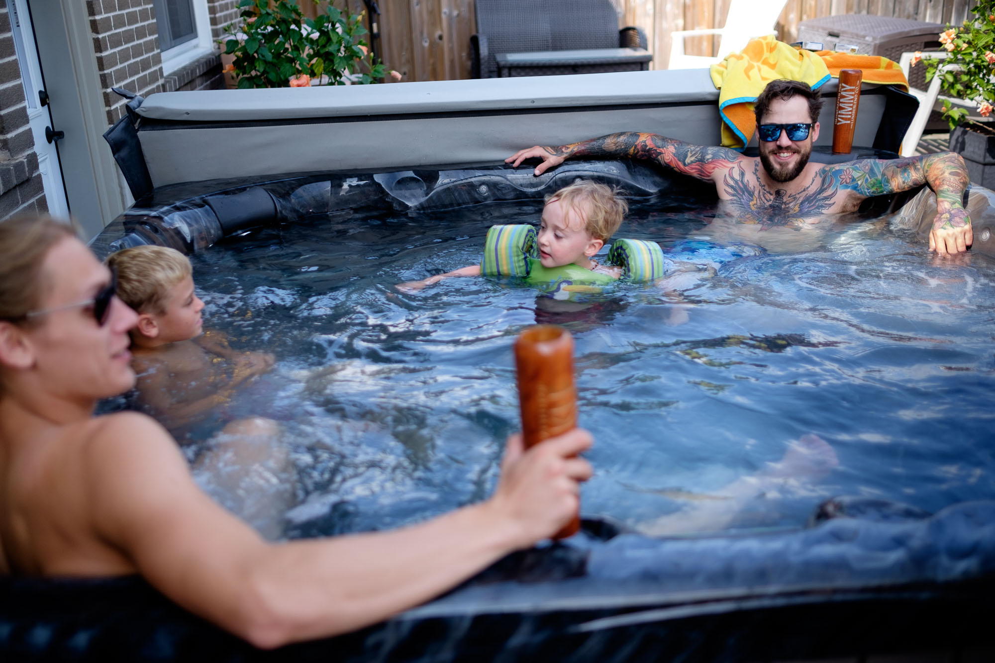 The groom relaxes in a hot tub before his backyard wedding in Ontario, Canada.