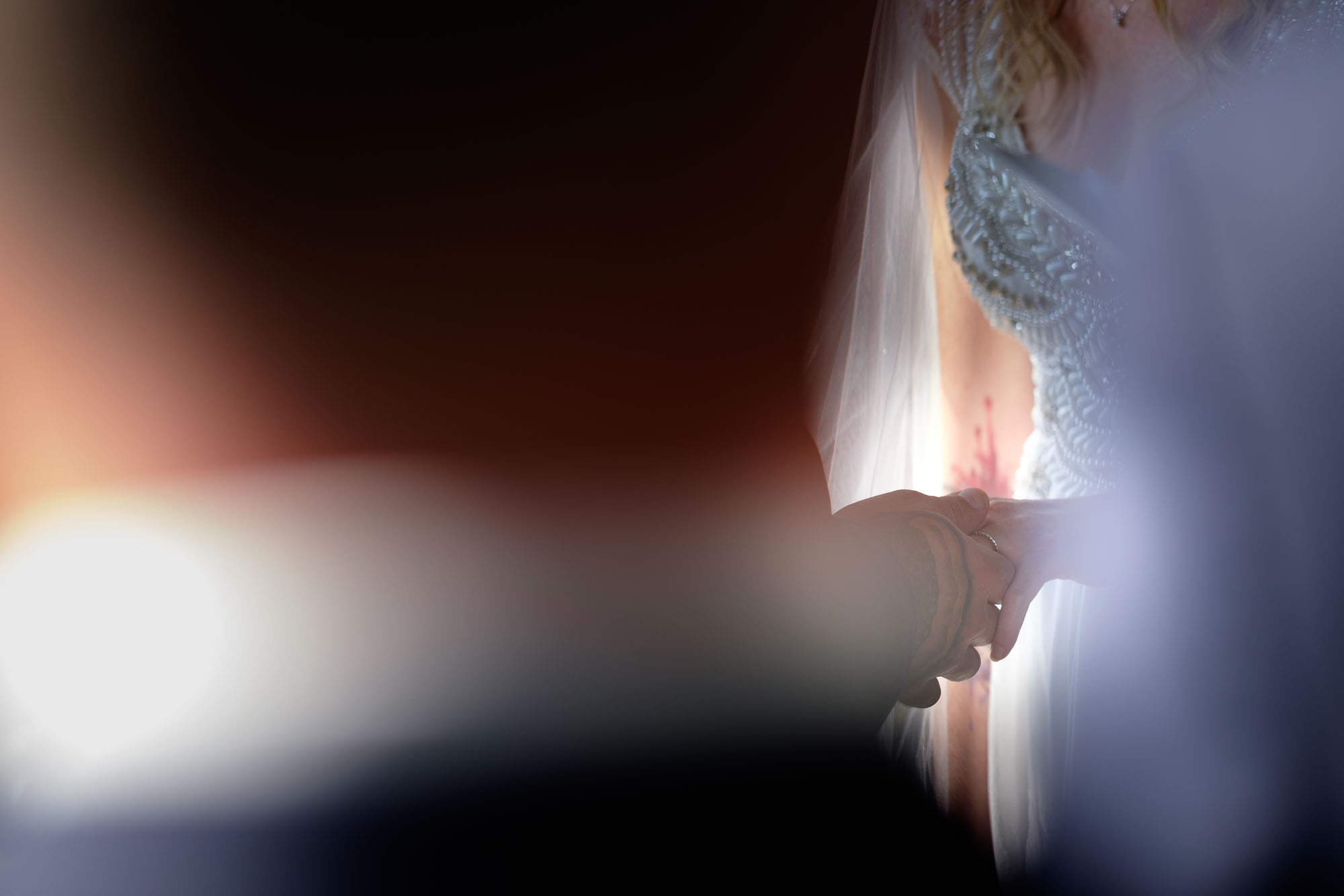 The bride and groom exchange wedding rings during their outdoor ceremony in their backyard in Barrie, Ontario. Photograph by Scott Williams.