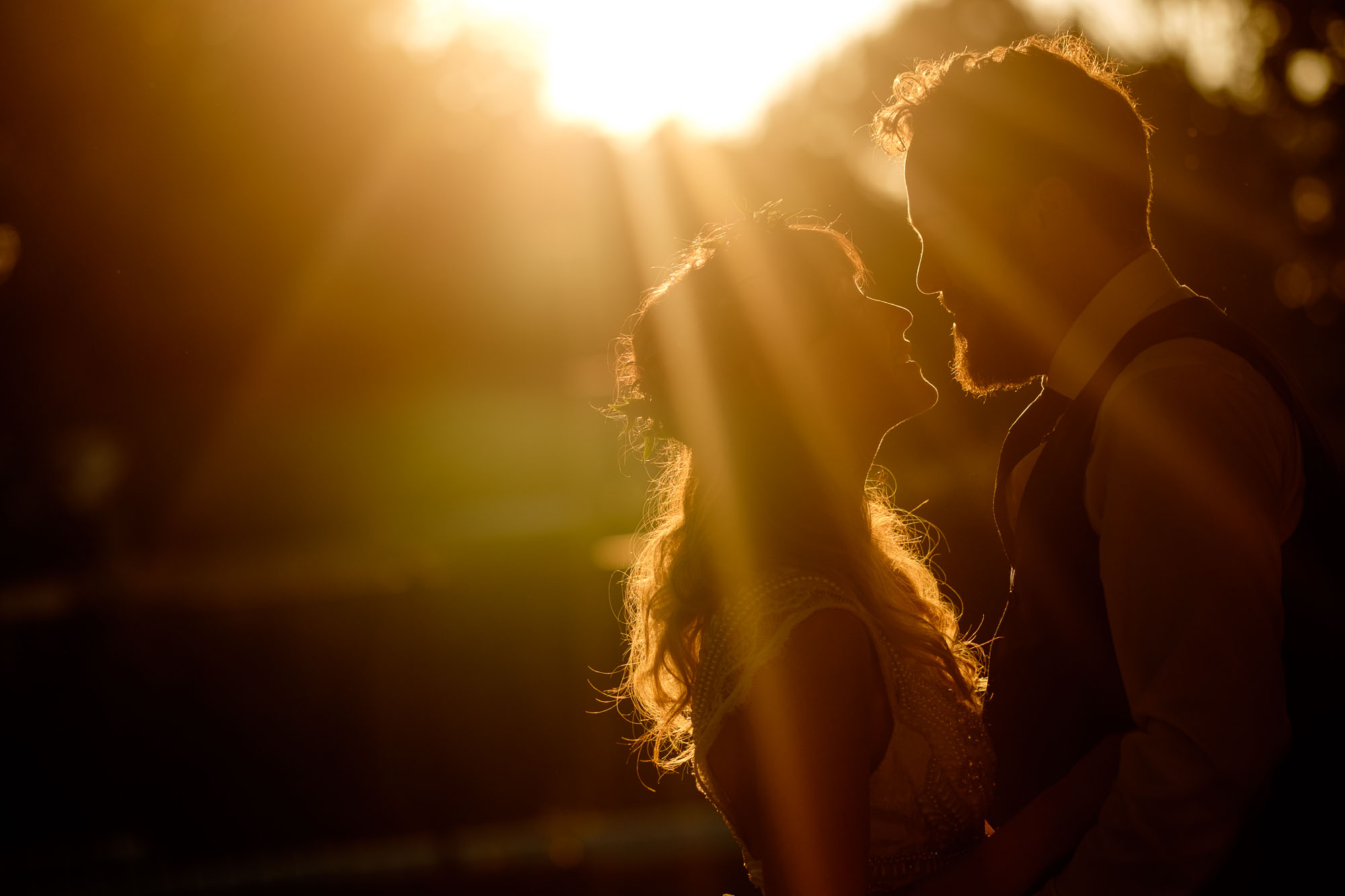Kristin and Adam pose for a wedding portrait at sunset during their backyard wedding reception in Barrie, Ontario. Photograph by Scott Williams.