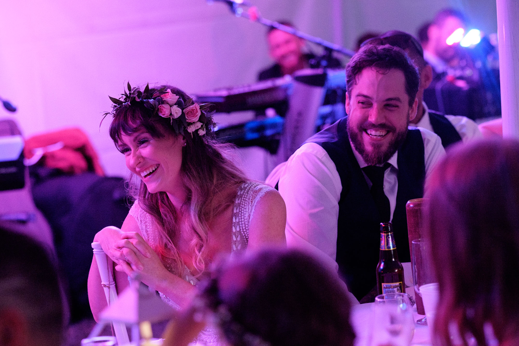 Kristin and Adam laugh during a toast at their backyard wedding reception in Barrie, Ontario. Photograph by Scott Williams.