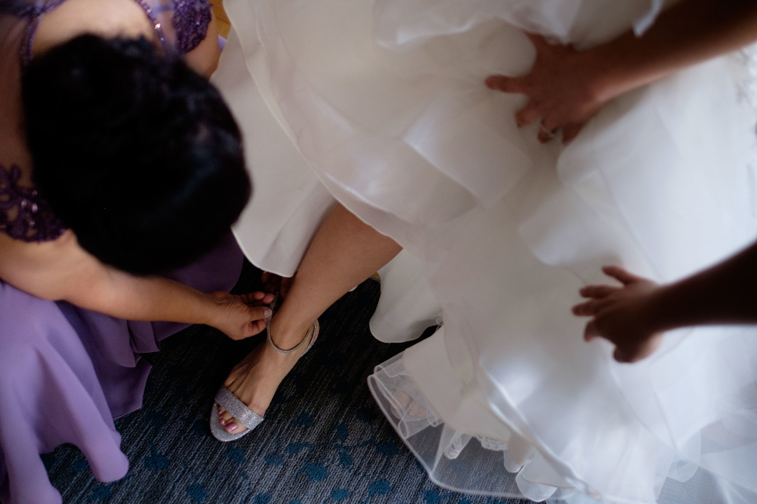  Linda gets help with her shoes as she gets ready for her wedding at the Hart House in Toronto. 