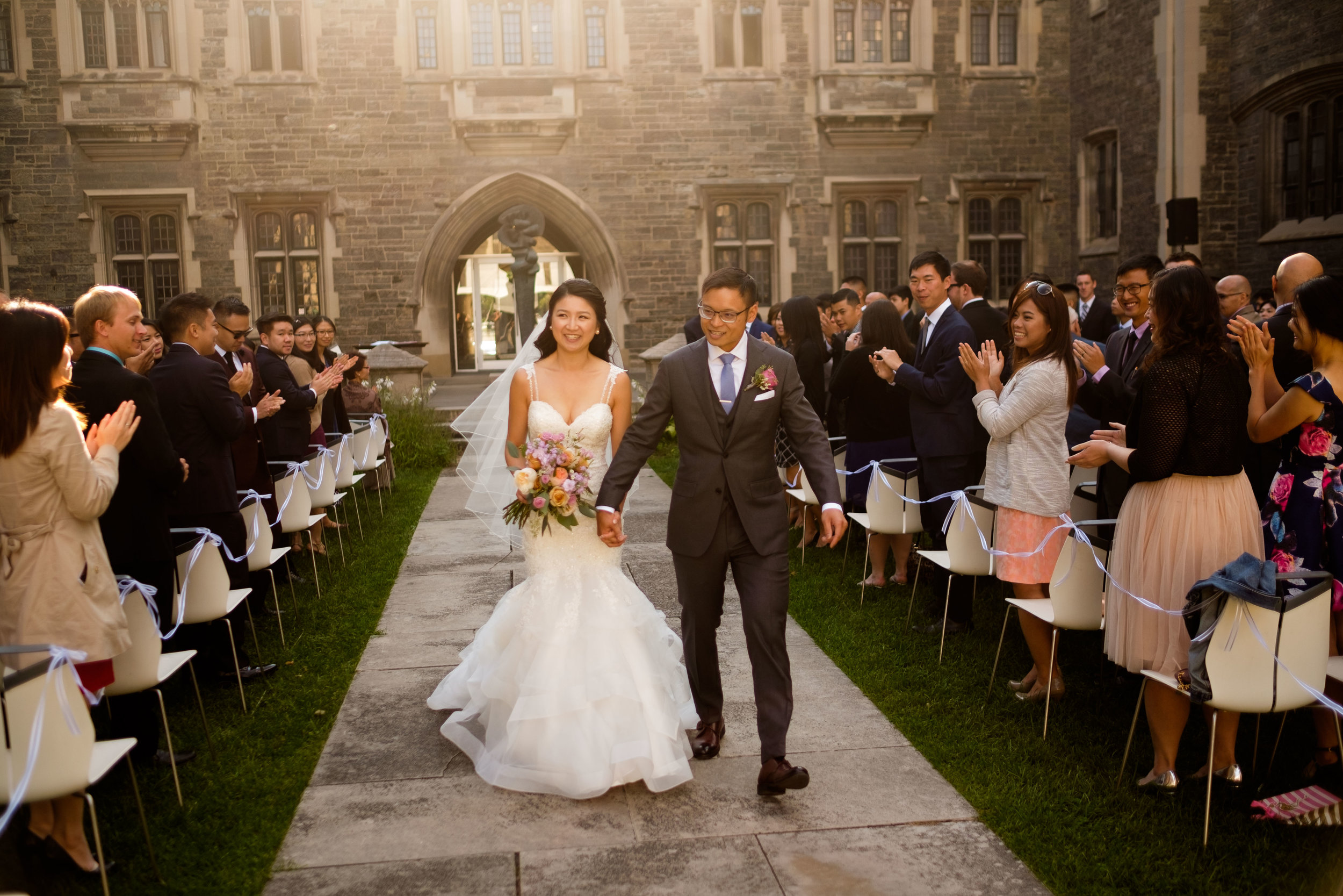  Linda + Andrew walk down the aisle during their outdoor wedding ceremony at the Hart House in Toronto. 