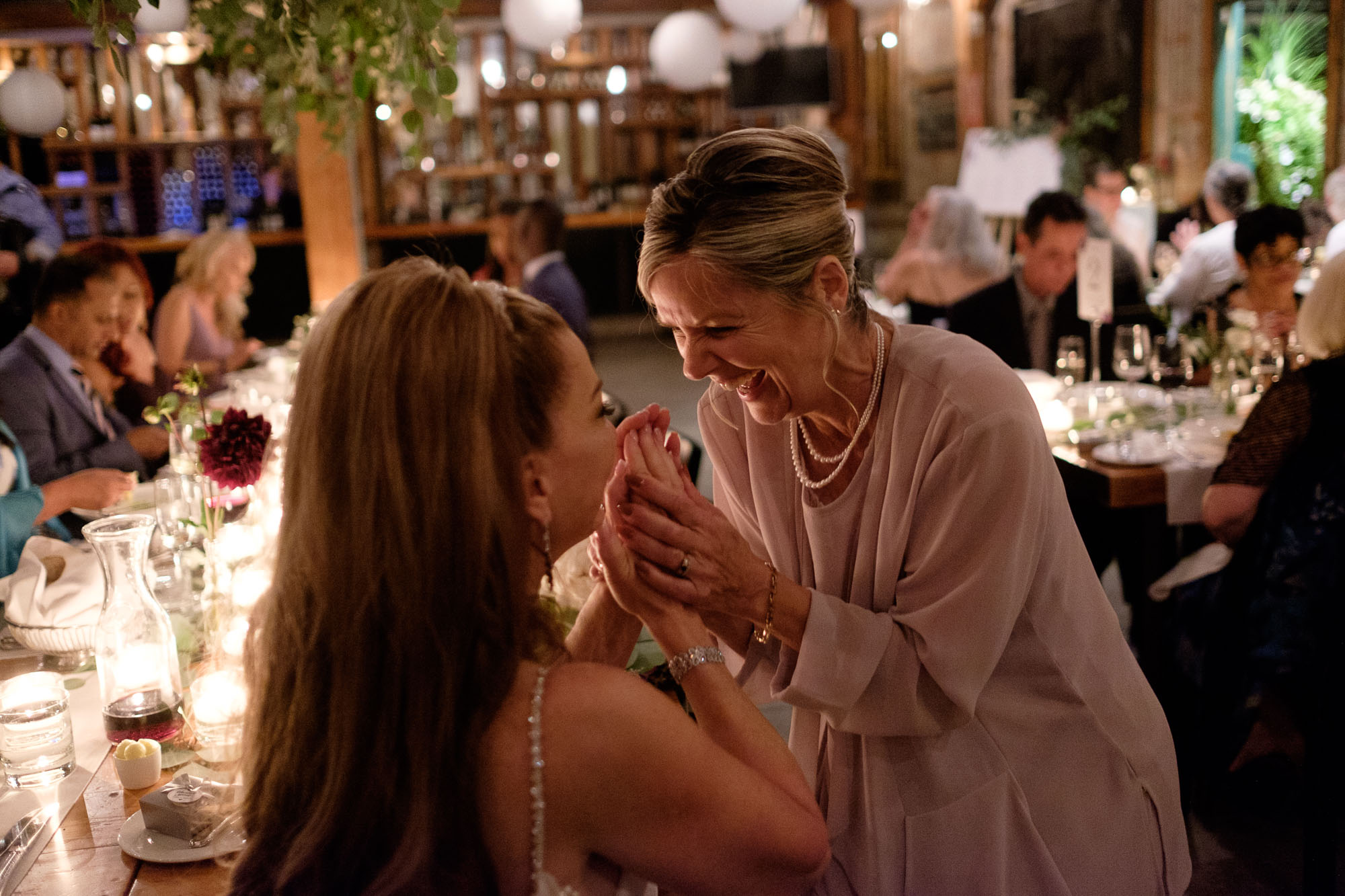  Cindy and one of her guests share a laugh during their wedding reception at Archeo in the Distillery District. 