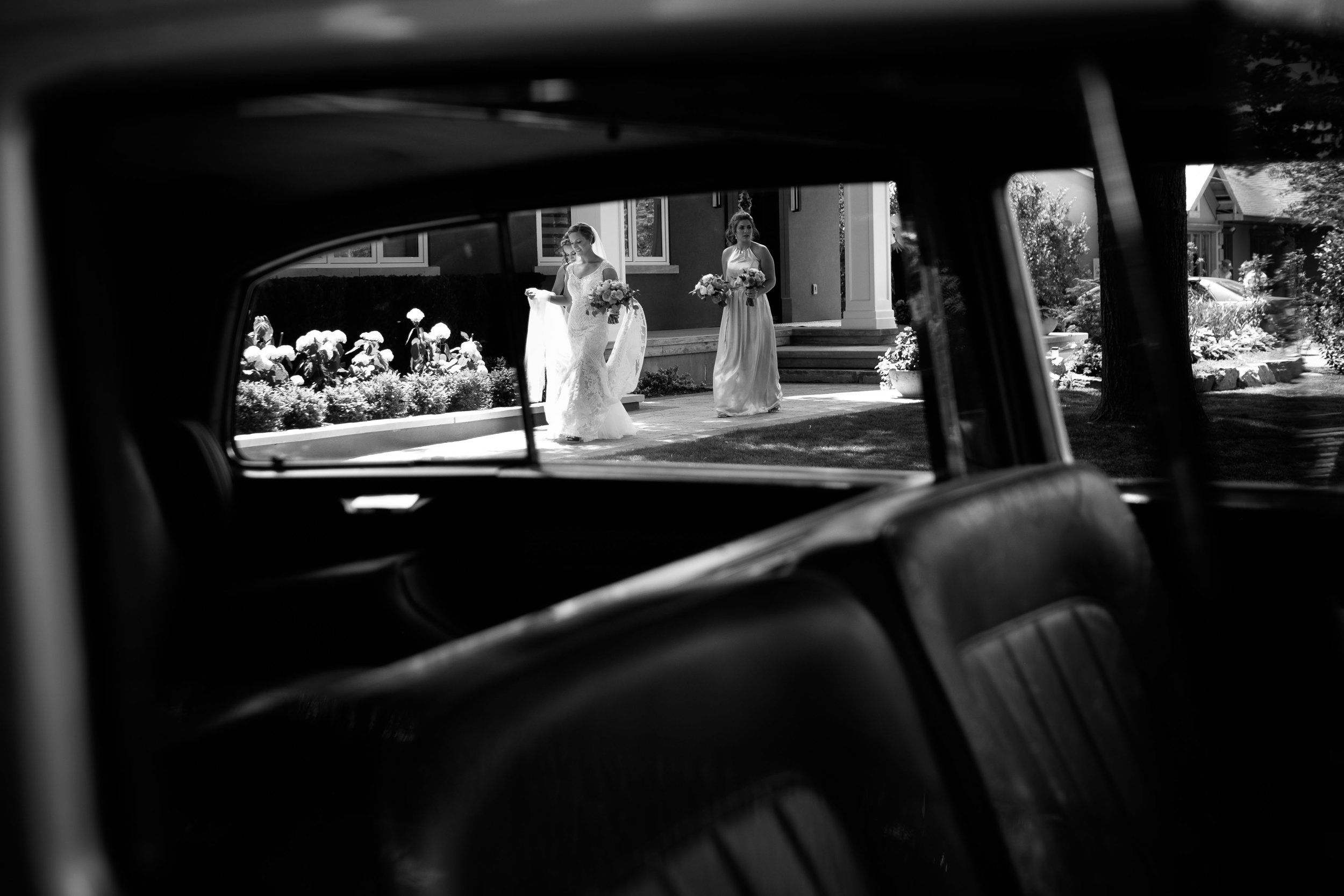 Sabrina leaves her parents house to ride in a classic Rolls Royce before her wedding ceremony.