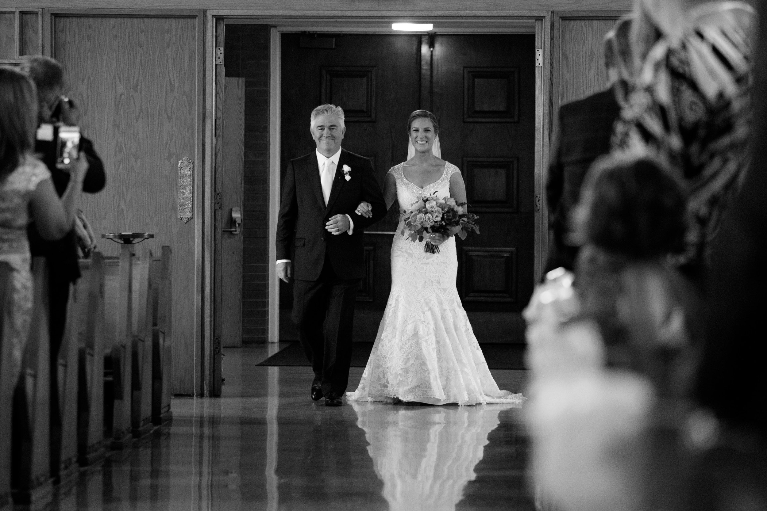 Sabrina and her dad walk down the aisle during her wedding ceremony in Toronto.
