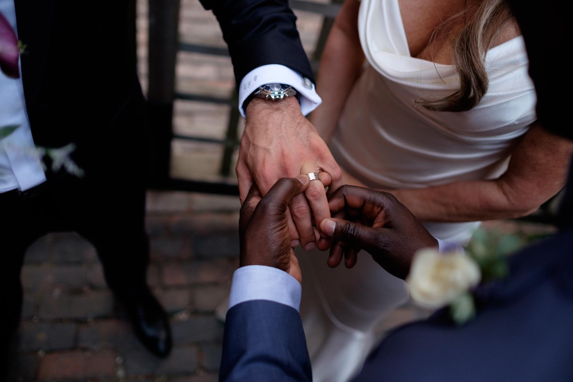 the groom shows off his new wedding ring after the outdoor ceremony at Archeo in Toronto.
