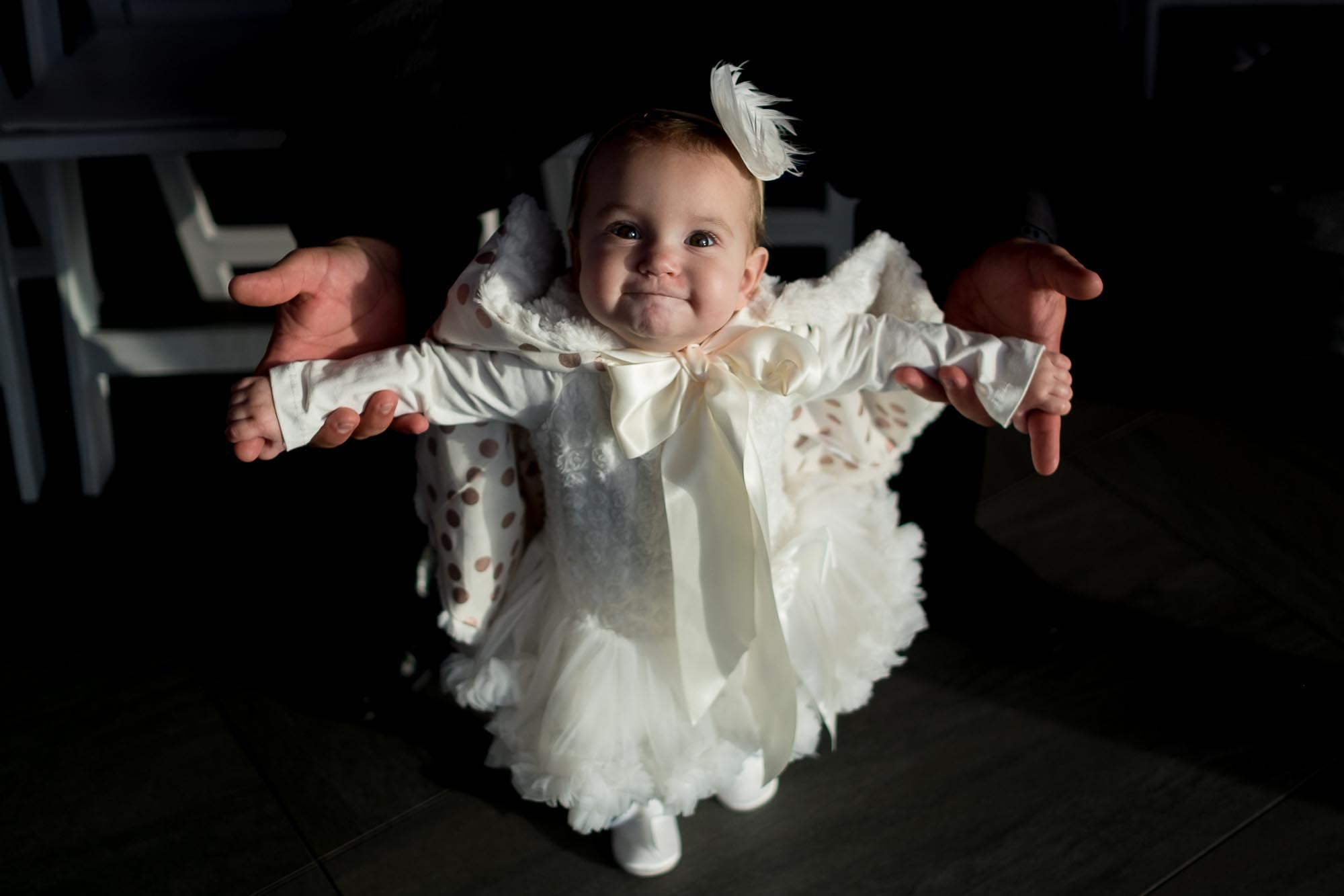  the bride's niece enjoys the wedding ceremony at the Cambridge Mill. 