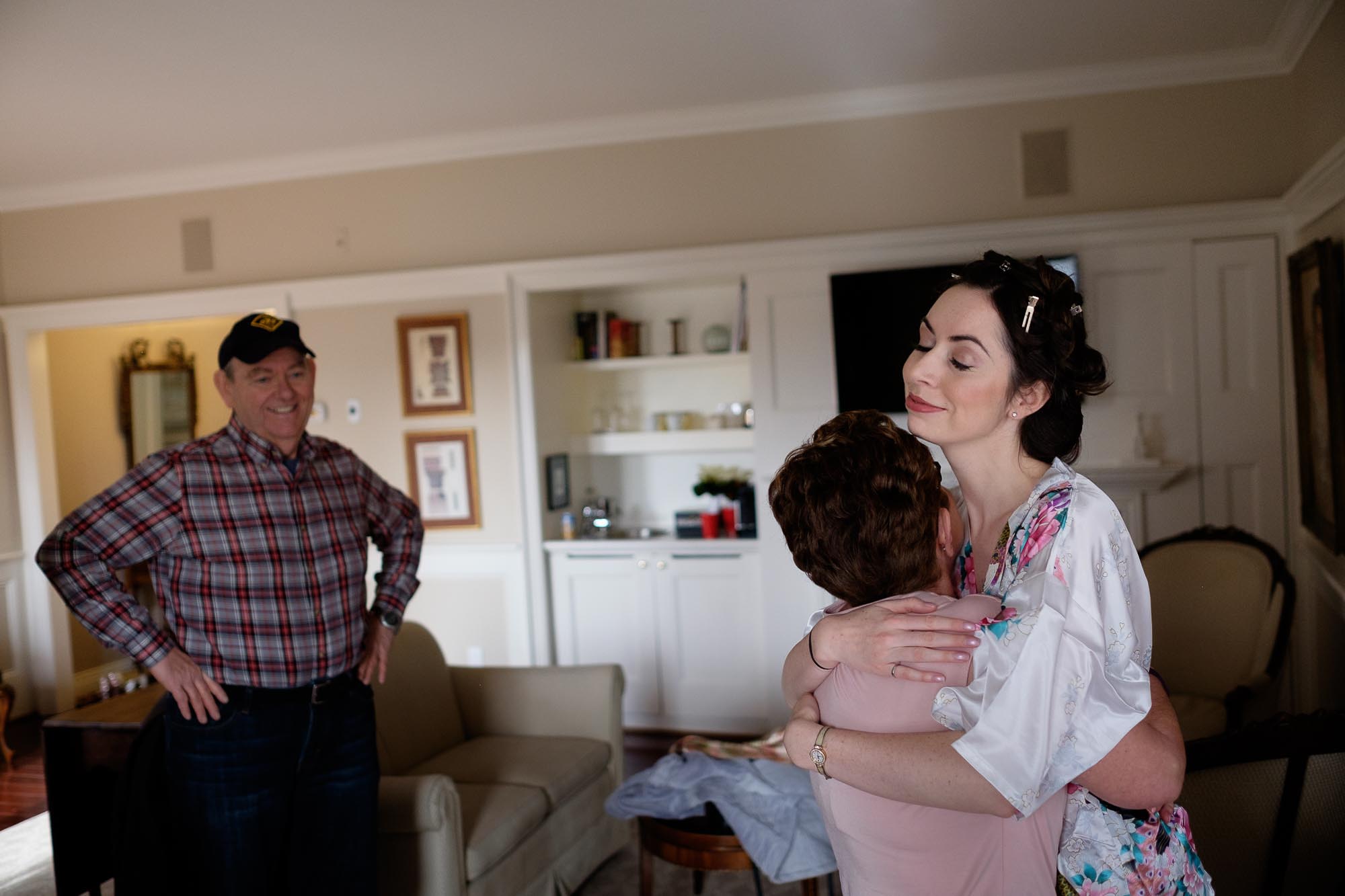  the bride greets her parents in her hotel suite at Langdon Hall before her outdoor winter wedding. 