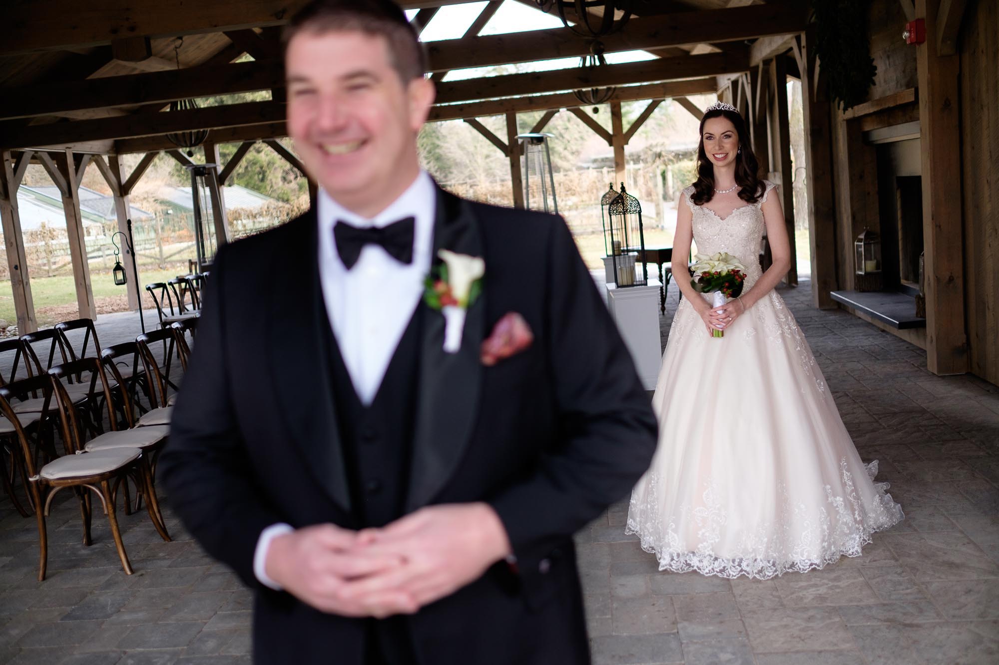 The bride and groom have their first look in Langdon Hall's Summer Room before their outdoor ceremony.