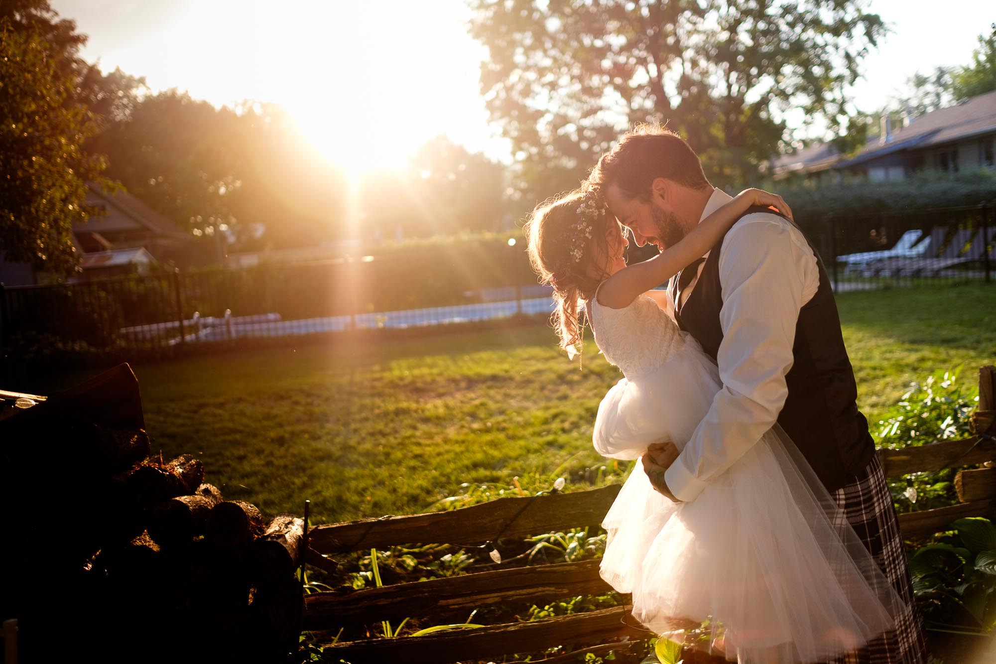  the groom gives his daughter a hug after the ceremony at a backyard wedding in Barrie, Ontario. 