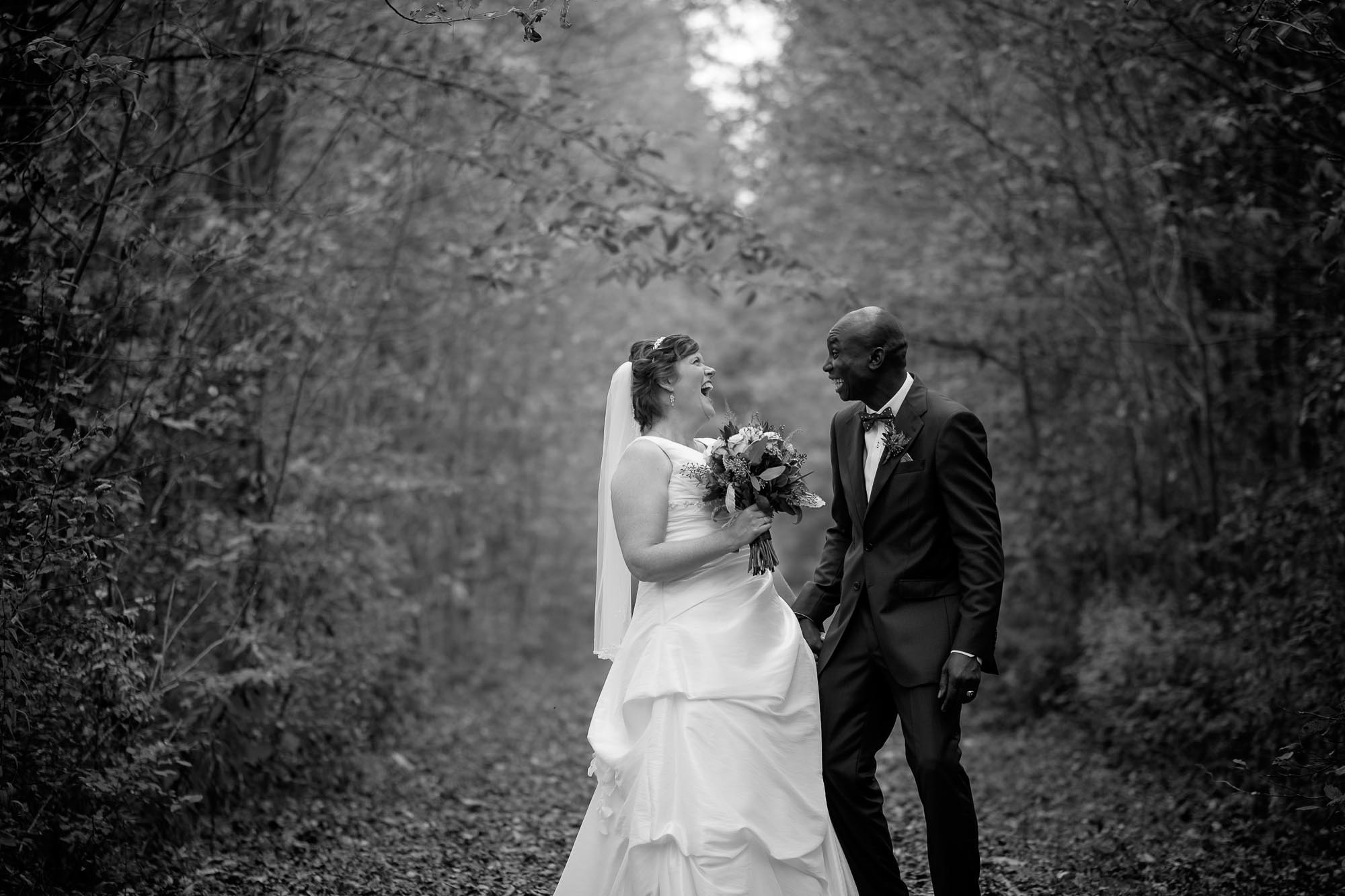  the bride and groom share a laugh during their wedding portraits in Listowell, Ontario. 