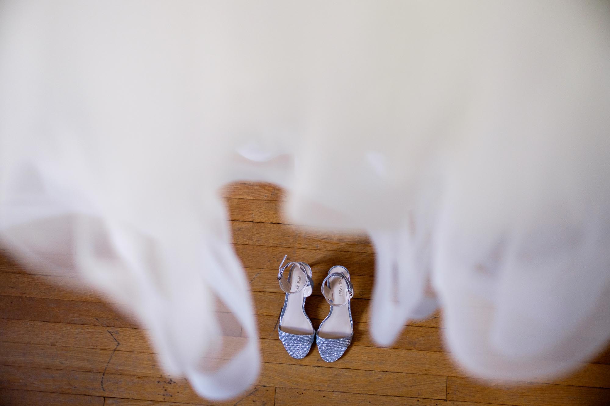  A wedding detail photograph of the brides dress and shoes from a wedding at the Hart House in Toronto, Ontario. 