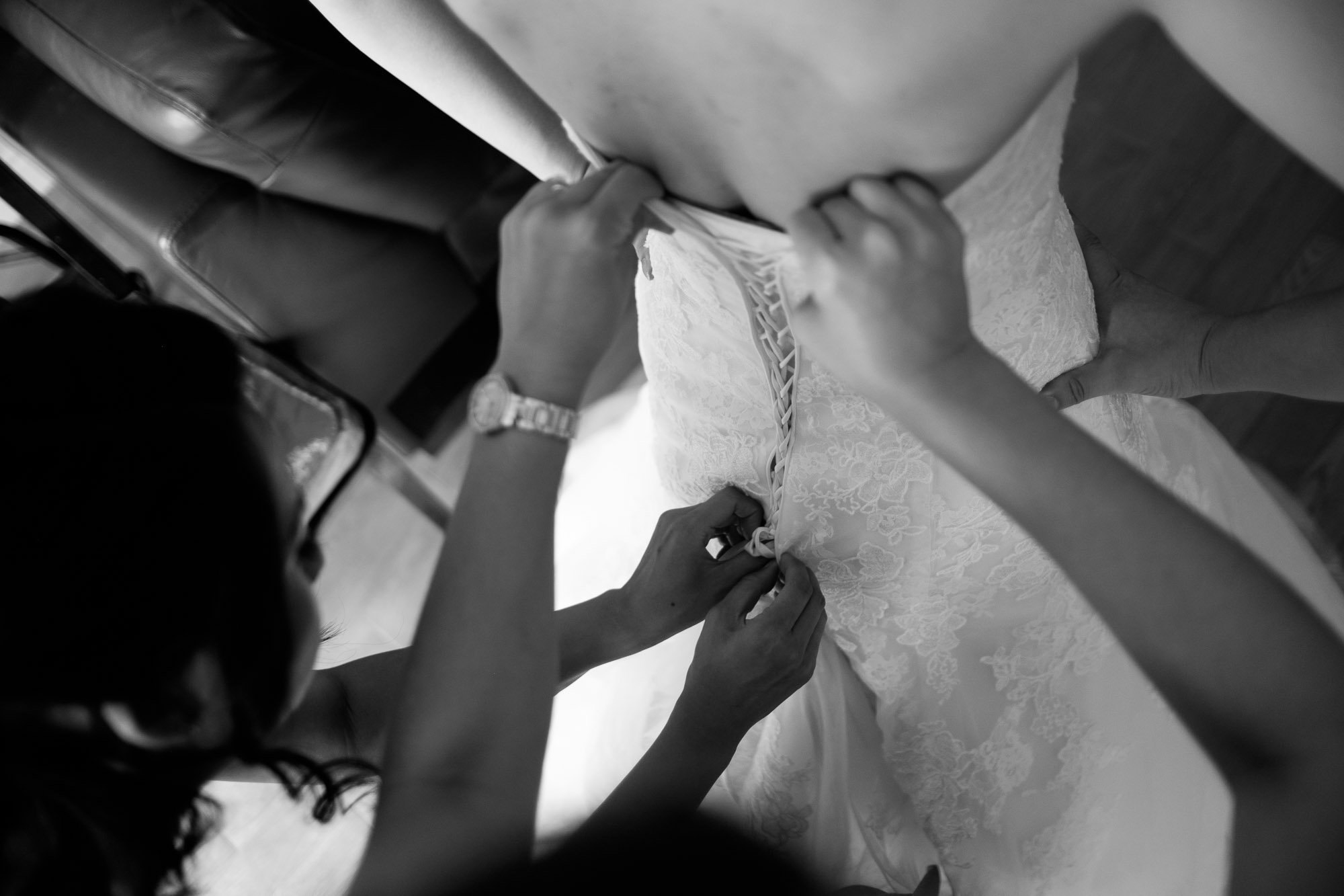  The bride has her dress adjusted by her bridesmaids as she gets ready for her Waterstone Estates wedding in Toronto. 