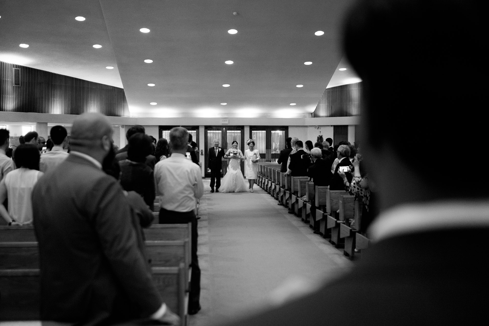  The groom sees his bride walking down the aisle for the first time during their Roman Catholic wedding ceremony in Toronto. 