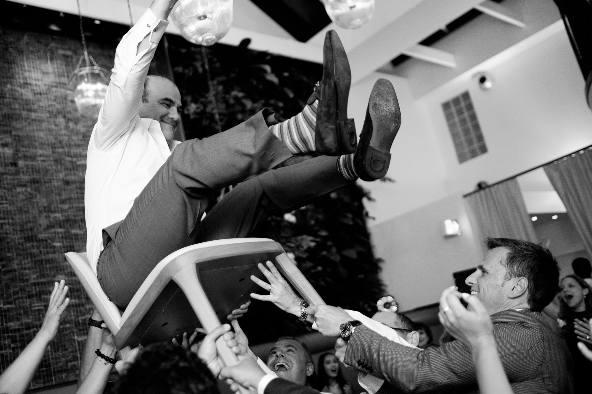 The groom is lifted up during dancing at a Jewish wedding reception in Toronto’s Yorkville neighbourhood.
