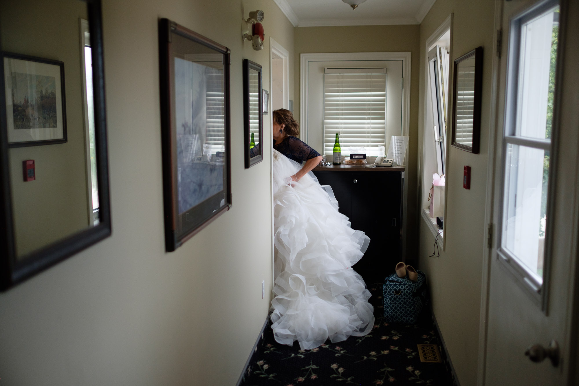  The wedding dress is moved to the getting ready suite at the Hessenland Inn before Alex + Colton’s outdoor wedding ceremony. 