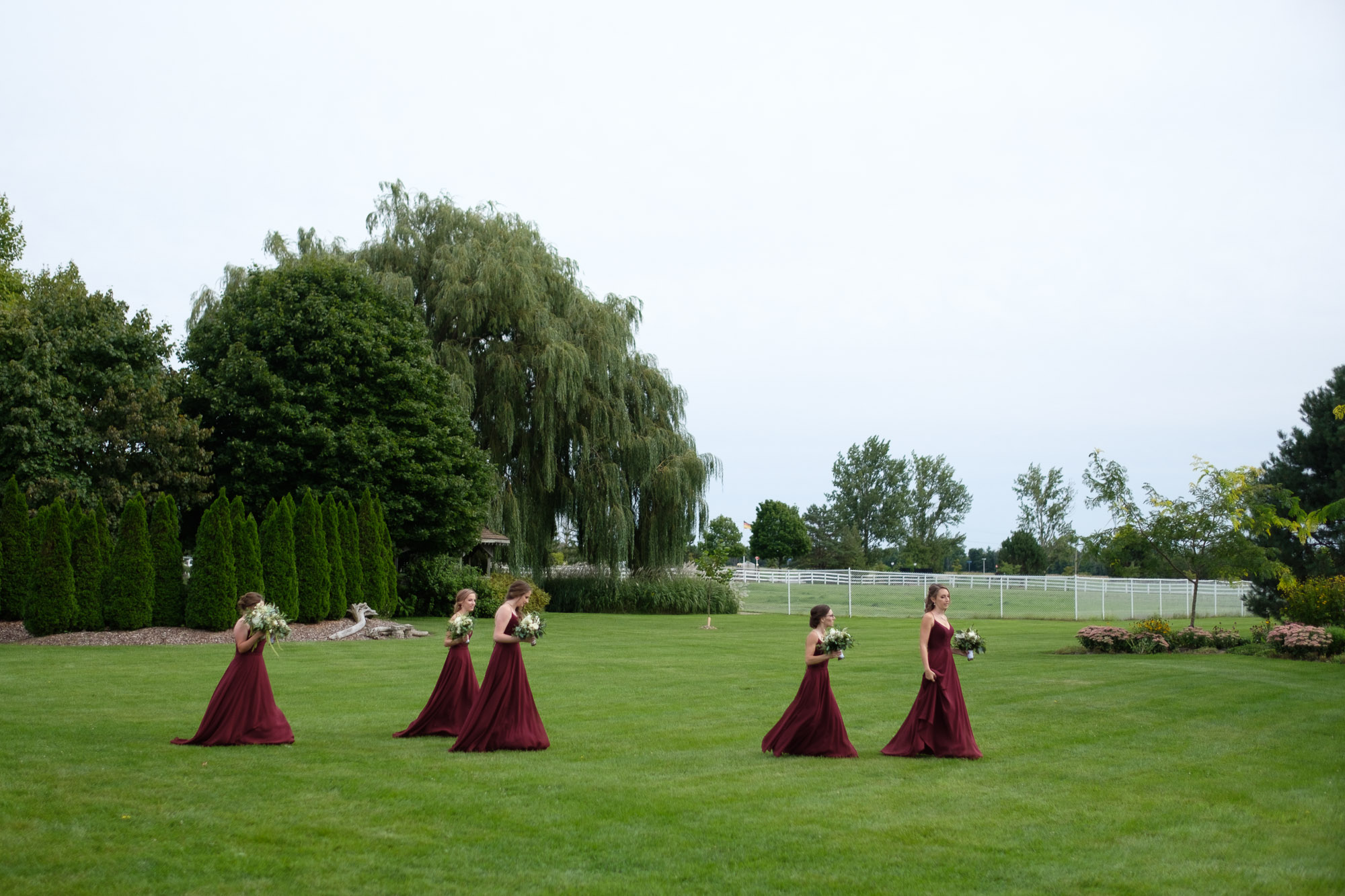  The bridesmaids walk to the outdoor wedding ceremony at the Hessenland Inn in Southwestern Ontario. 