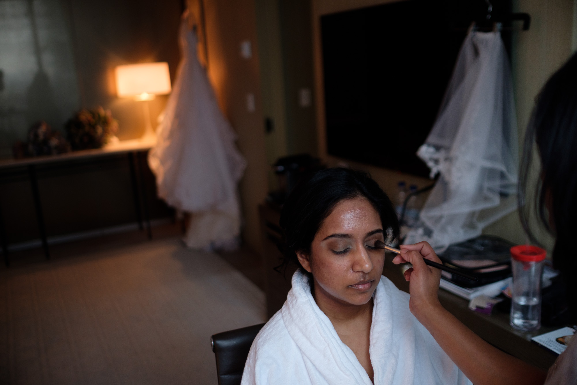  The bride has her makeup done in her suite at the Toronto Four Seasons hotel before her new years eve wedding at the Toronto Reference Library Appel Salon. 