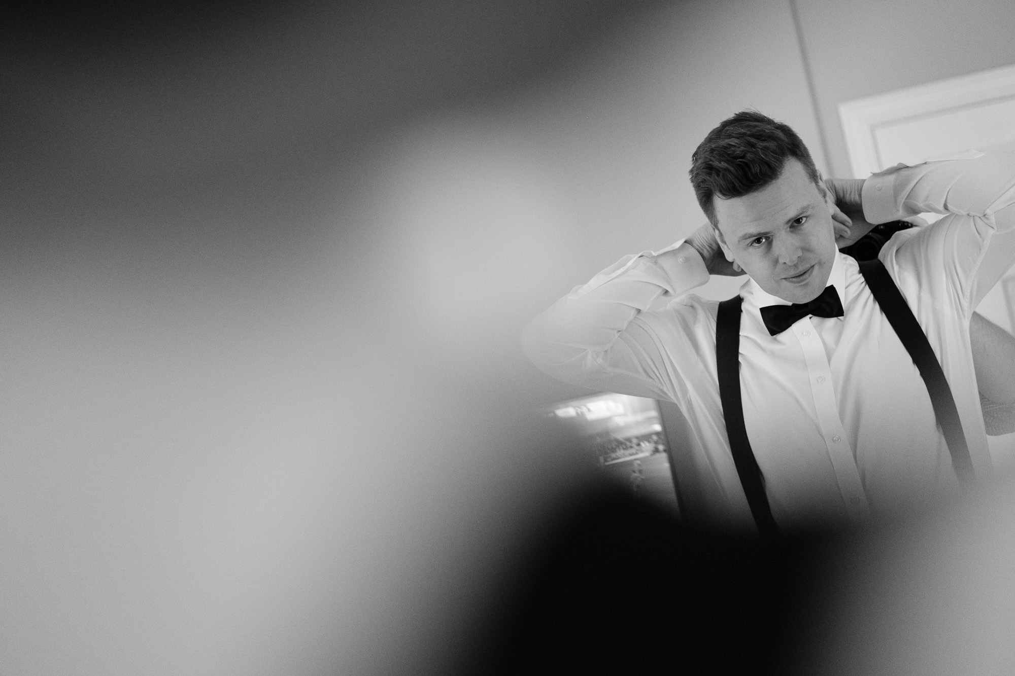  The groom adjusts his bowtie while getting ready for his wedding at the King Edward Hotel in Toronto. 