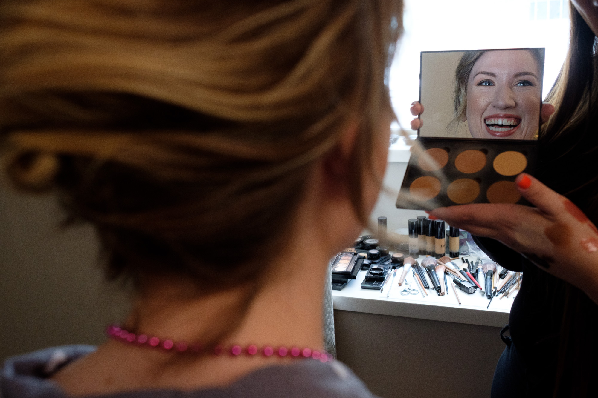  A bridesmaid checks her make up while getting ready at Toronto’s King Edward Hotel before the wedding at the Enoch Turner Schoolhouse. 