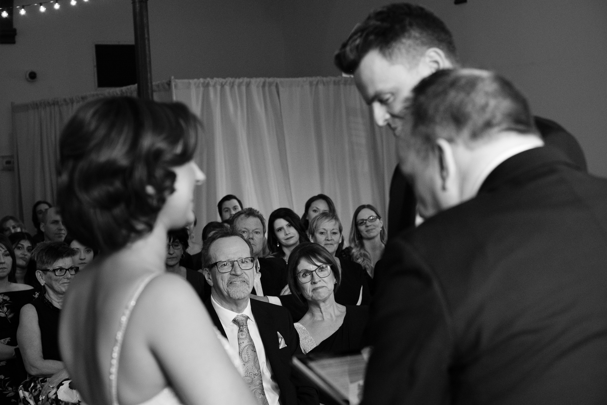  The brides parents look on during the wedding ceremony as the bride and groom exchange vows at the Enoch Turner Schoolhouse in Toronto. 