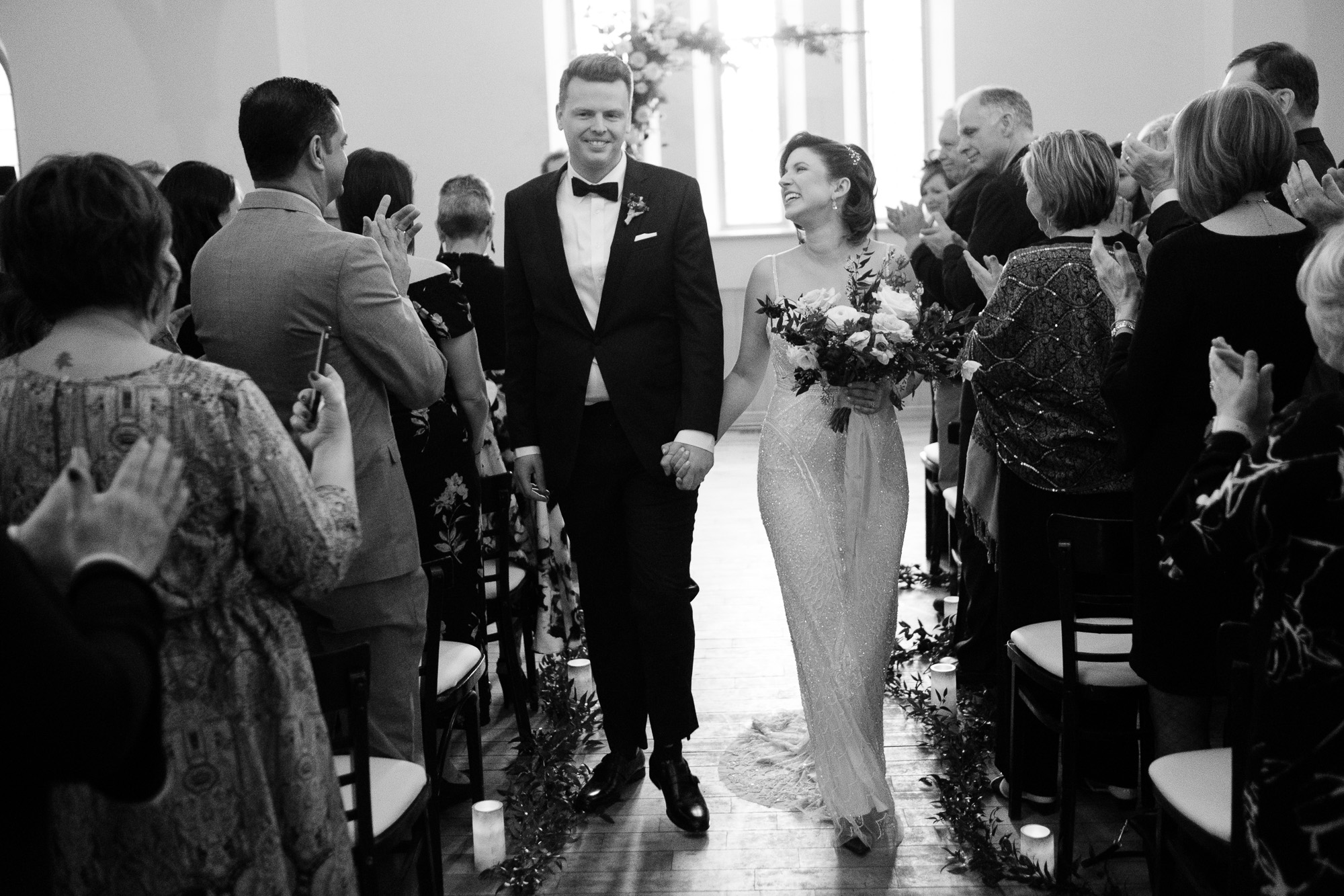 The bride and groom recede up the aisle after their wedding ceremony at the Enoch Turner School house in Toronto.