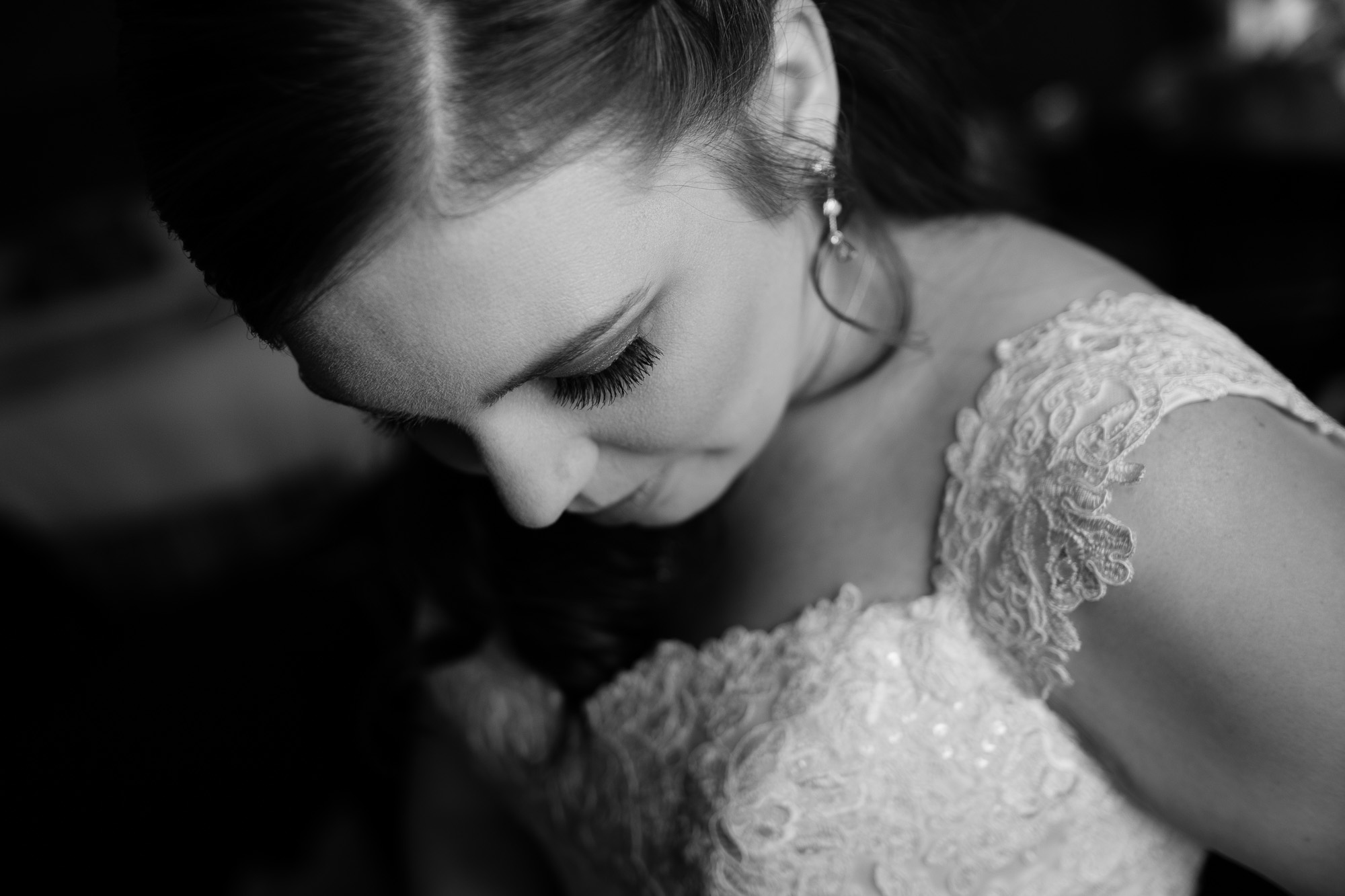 A casual portrait of the bride in her wedding dress as she gets ready for wedding ceremony at the Glenerin Inn just outside of Toronto.