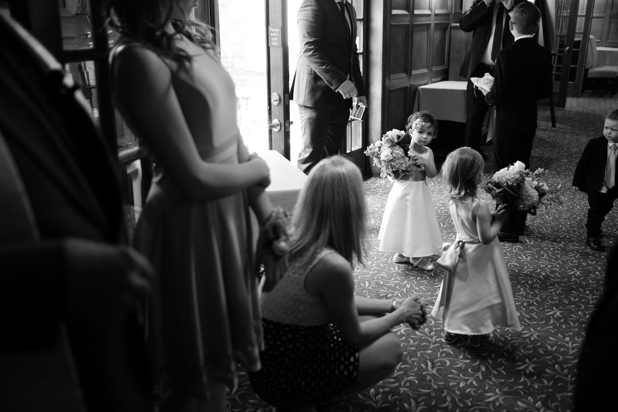  The flower girls wait in anticipation for their turn to lead the bride the down the aisle during the wedding ceremony at the Glenerin Inn outside of Toronto. 