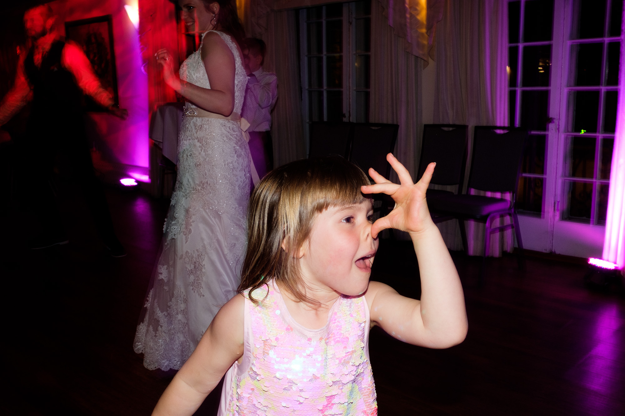 The flower girl hams it up on the dance floor late into the night during the wedding reception at the Glenerin Inn outside of Toronto.