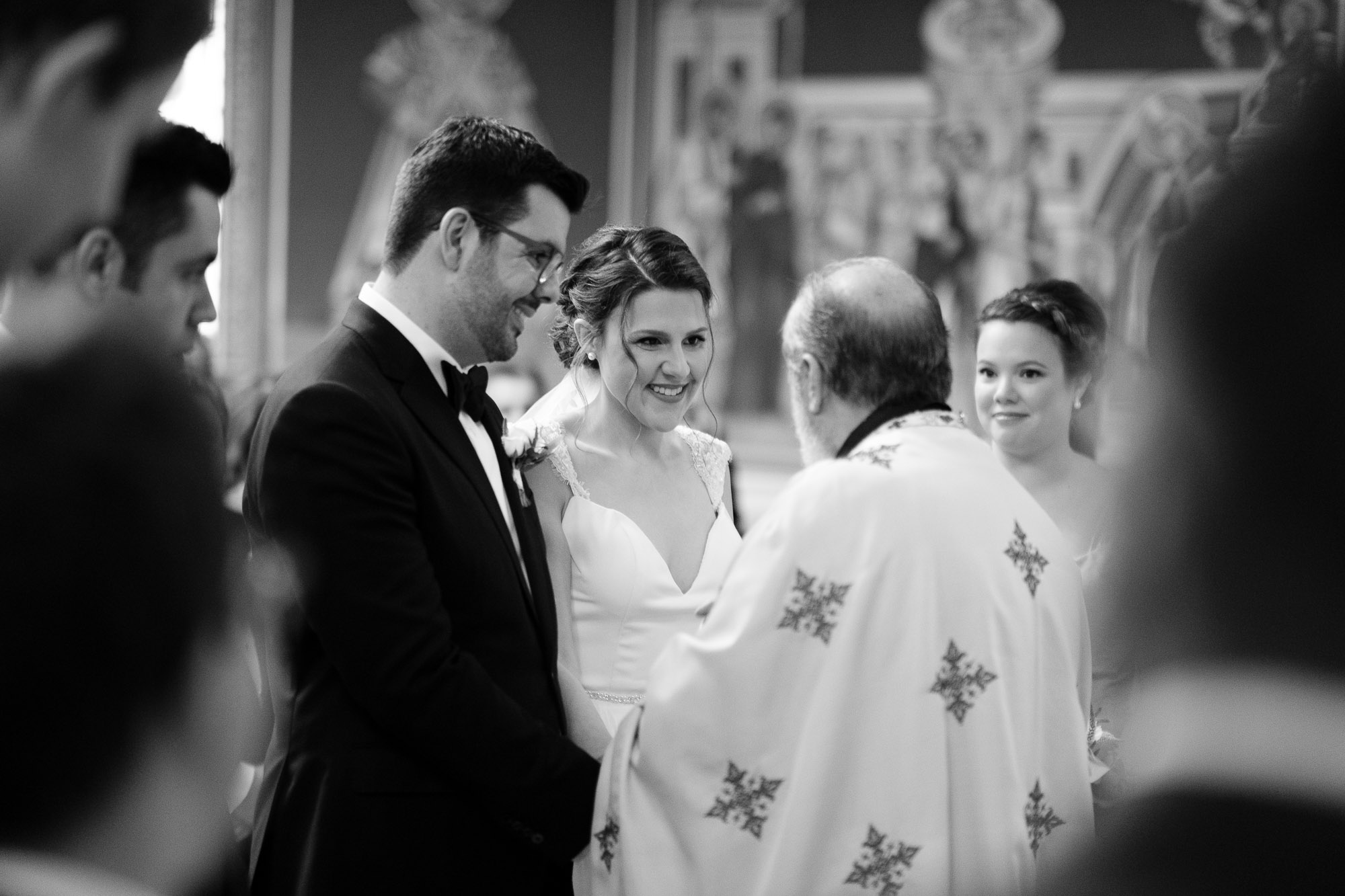 Katherine + Kosta exchange a laugh during their Greek Orthodox wedding ceremony at St. George’s Greek Orthodox Church in Toronto.