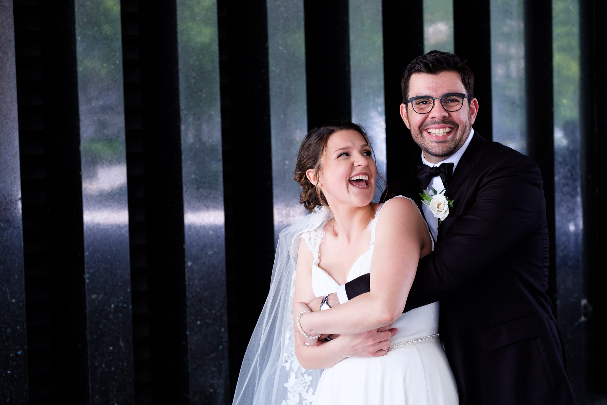 Katherine + Kosta share a laugh while having some wedding portraits taken near Osgoode Hall in Toronto before their wedding reception at Liberty Grand in Toronto.