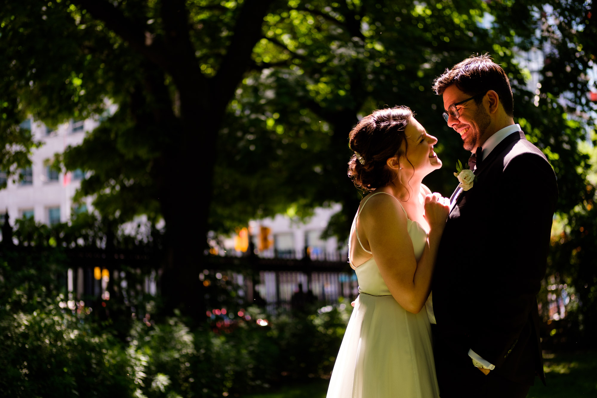 Katherine + Kosta share a laugh while having some wedding portraits taken near Osgoode Hall in Toronto before their wedding reception at Liberty Grand in Toronto.