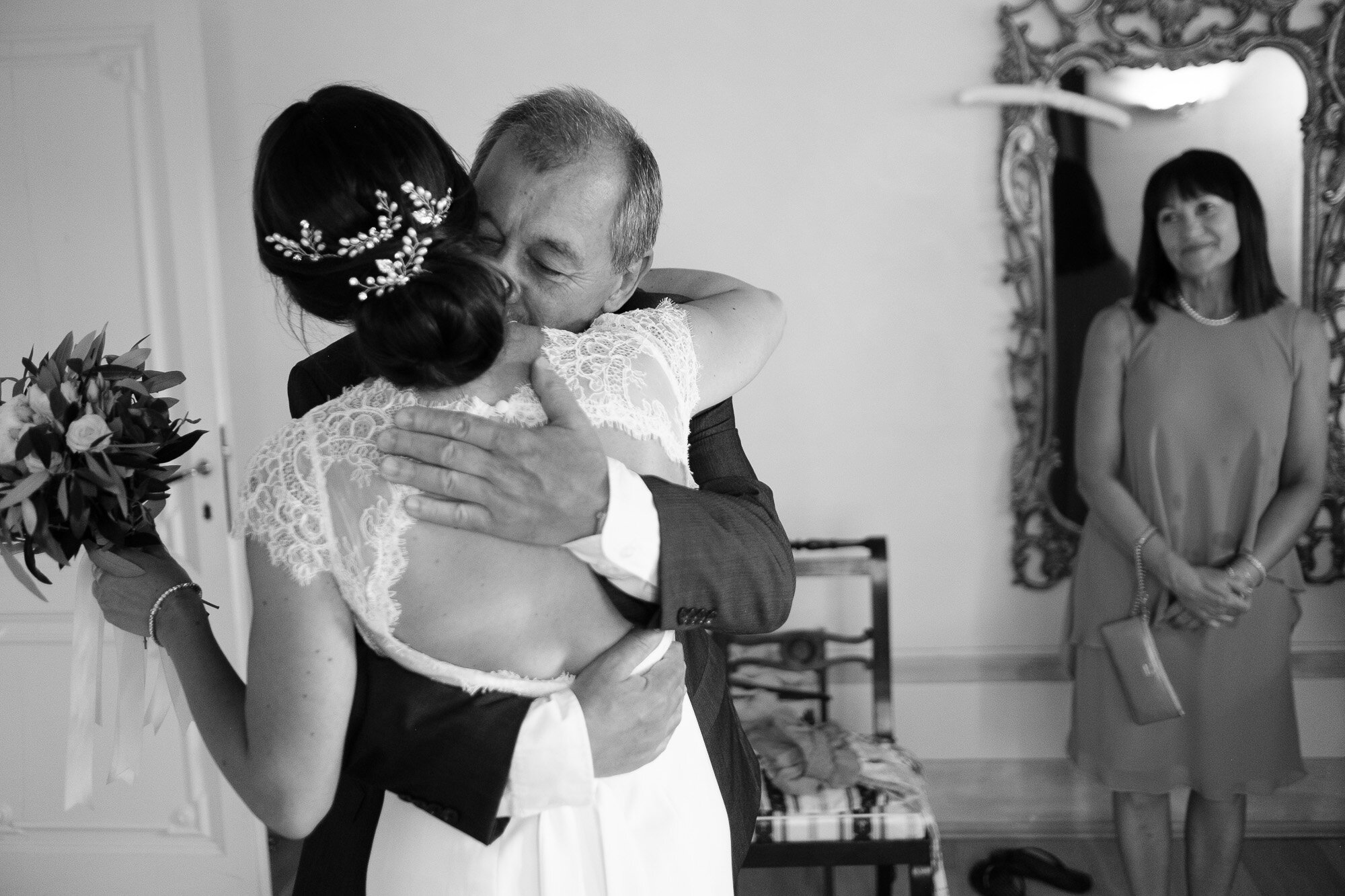  Elena receives a hug from her dad after seeing her for the first time in her wedding dress before the wedding ceremony at their destination wedding in Tuscany, Italy by wedding photographer Scott Williams (www.scottwilliamsphotographer.com) 