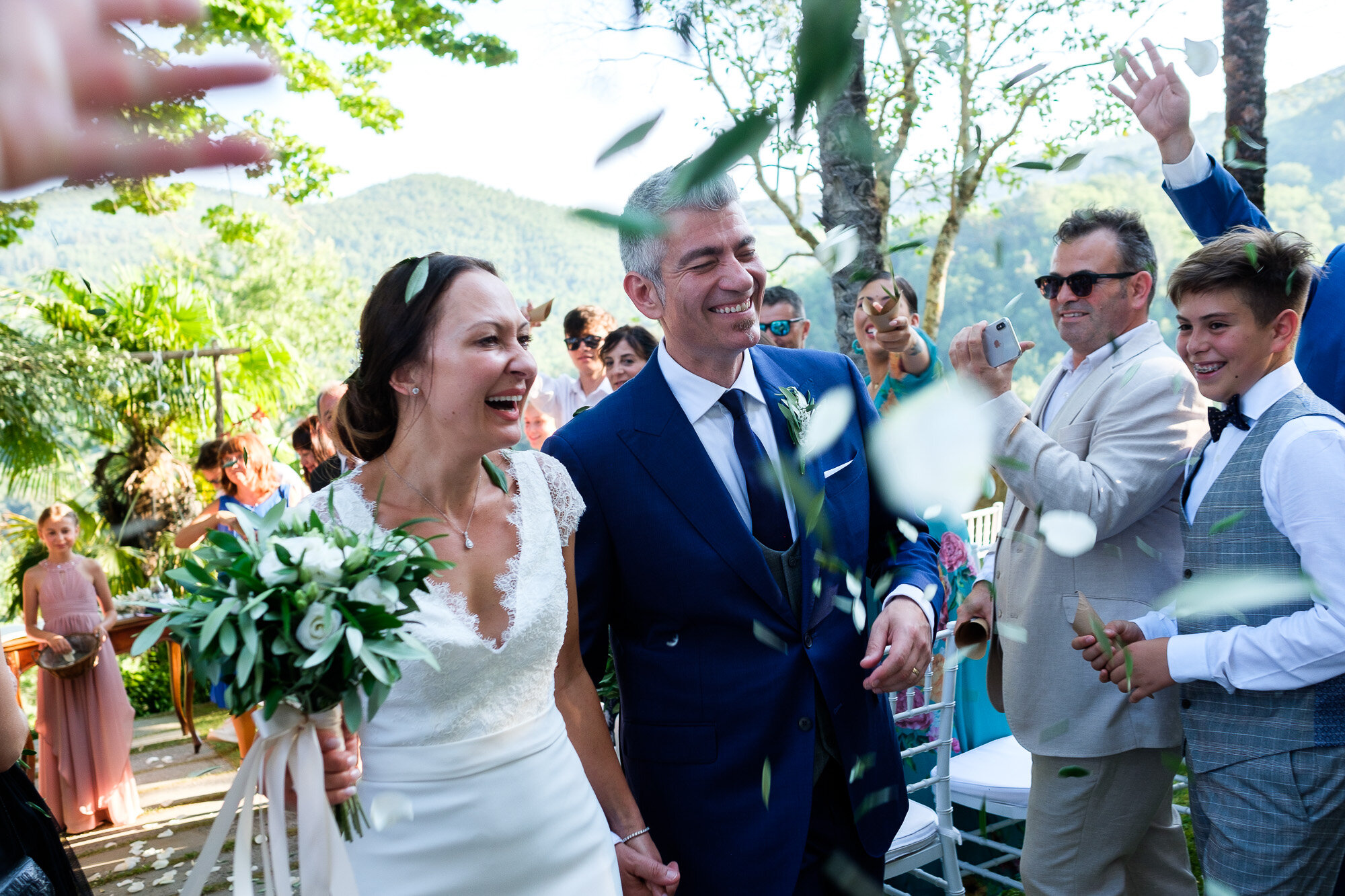  Elena + Steve are showered with confetti walking up the aisle during their wedding ceremony at a villa in Tuscany, Italy by wedding photographer (www.scottwilliamsphotographer.com) 