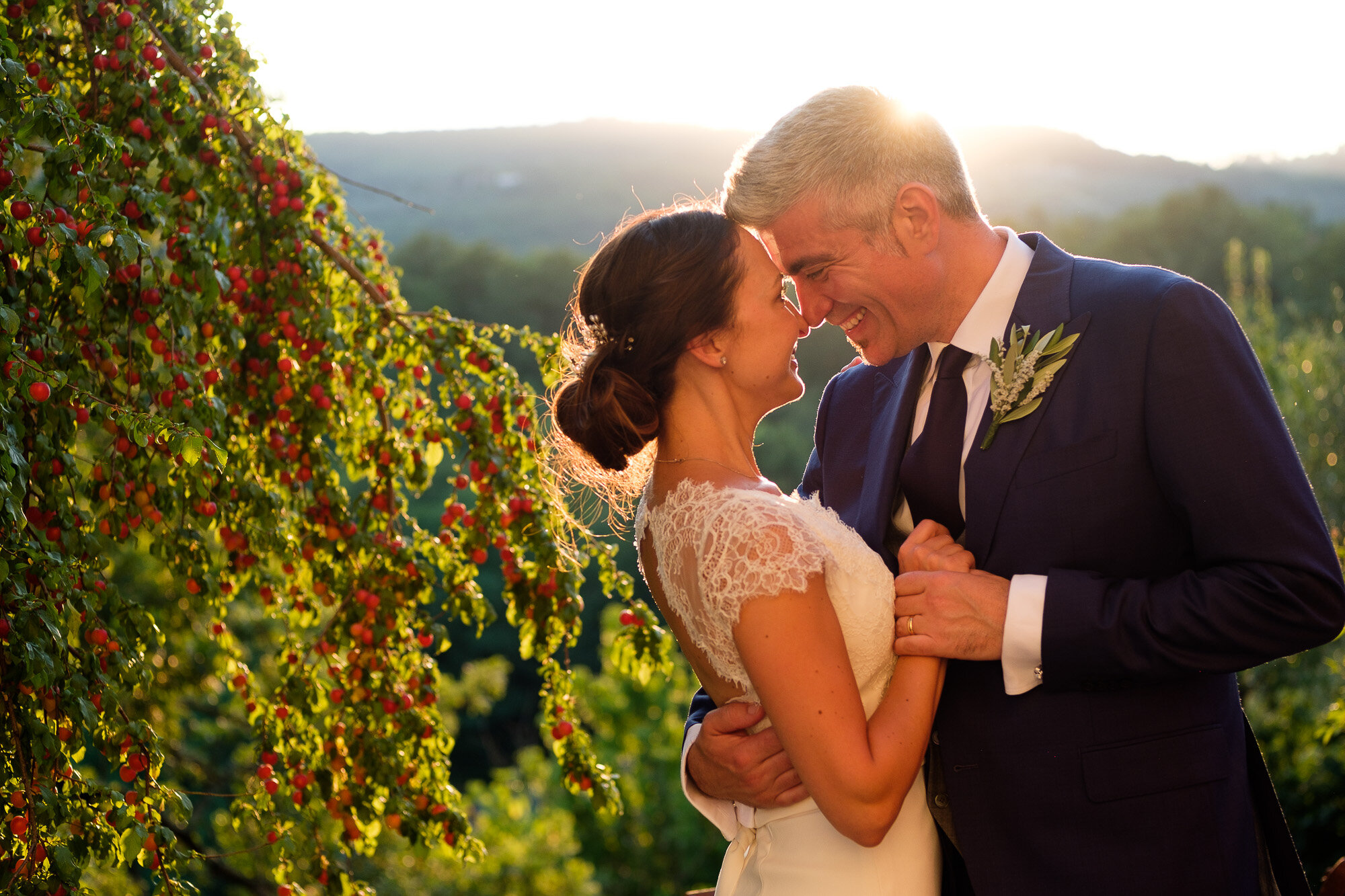  Elena + Steve pose for a relaxed golden hour sunset portrait overlooking the hills of Tuscany, Italy after their wedding ceremony by wedding photographer Scott Williams (www.scottwilliamsphotographer.com) 