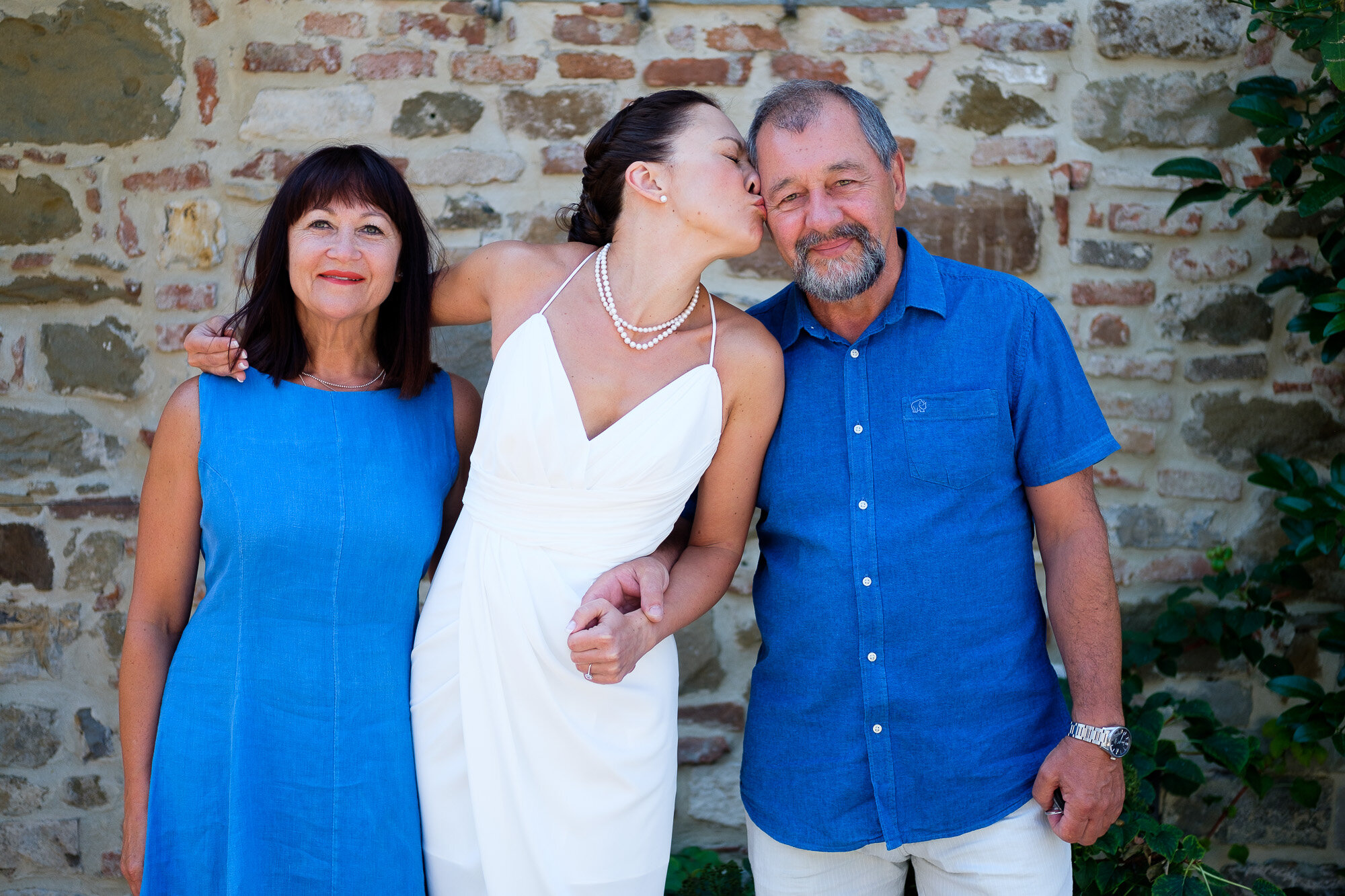  Elena poses for some portraits with her parents  before heading into the local town for their civil ceremony during their Tuscany destination wedding by wedding photographer Scott Williams (www.scottwilliamsphotographer.com) 