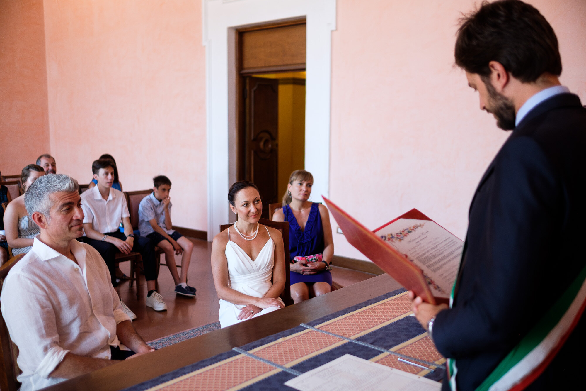  Elena and Steve listen to the local city official officiate their civil ceremony during their Tuscany destination wedding by wedding photographer Scott Williams (www.scottwilliamsphotographer.com) 