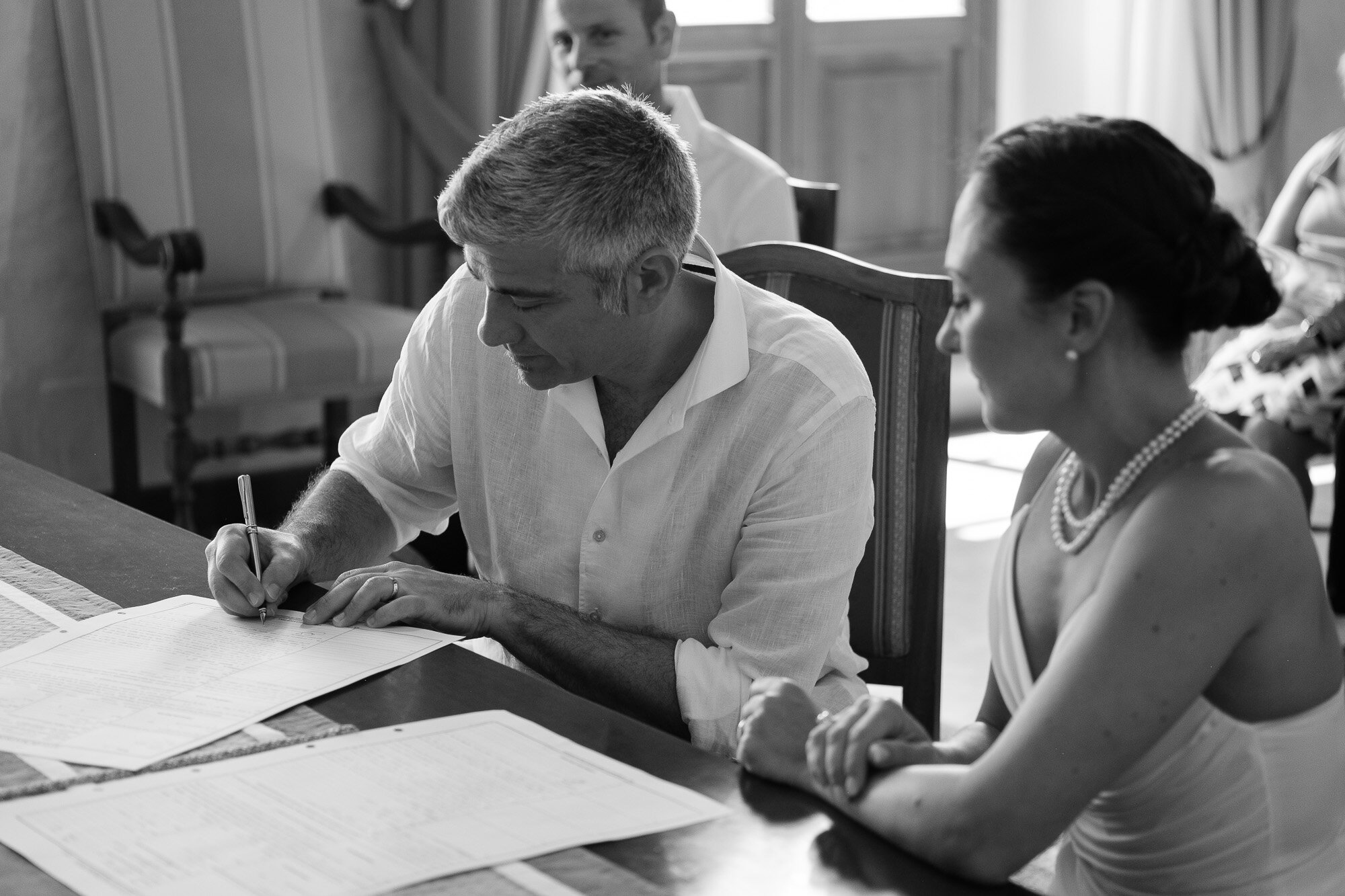  Elena + Steve sign the wedding registry during  their civil wedding ceremony at the local city hall during their destination wedding in Tuscany, Italy by wedding photographer Scott Williams (www.scottwilliamsphotographer.com) 