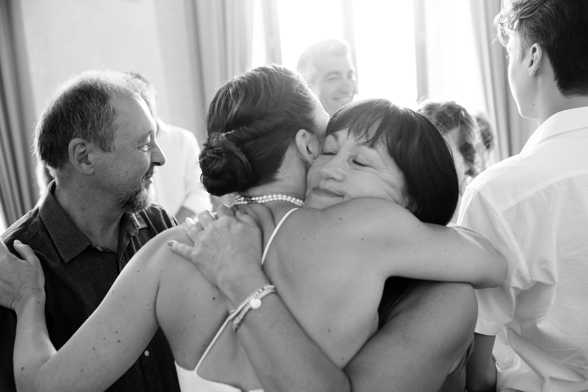  Elena gives her mom a hug after the civil ceremony at Pontassieve’s city hall during their destination wedding in Tuscany, Italy by wedding photographer Scott Williams (www.scottwilliamsphotographer.com) 