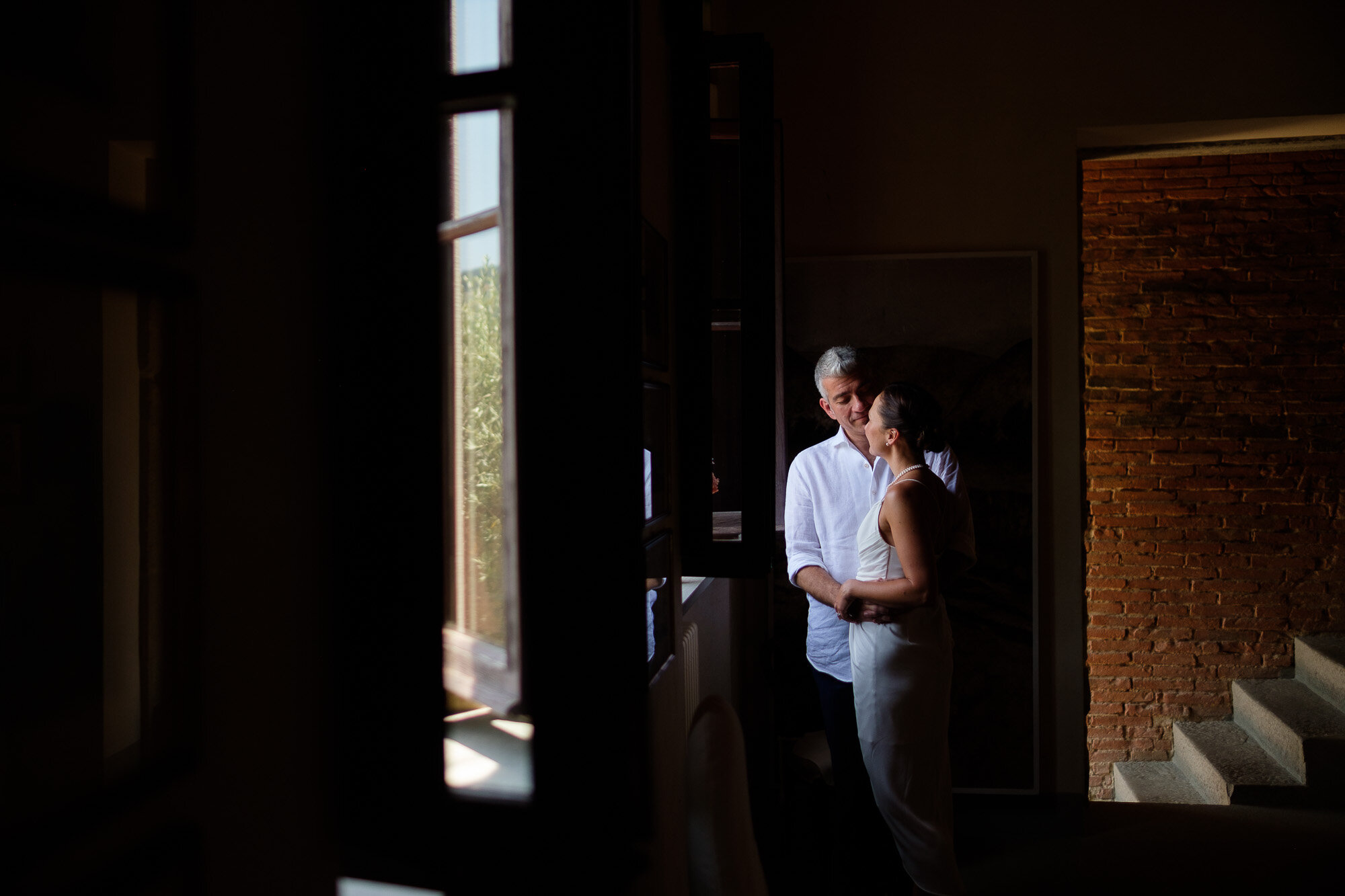  Elena and Steve pose for a portrait at the villa La Sorgente Di Francesca after their civil wedding ceremony at city hall in Pontassieve during their Tuscany destination wedding by wedding photographer Scott Williams 