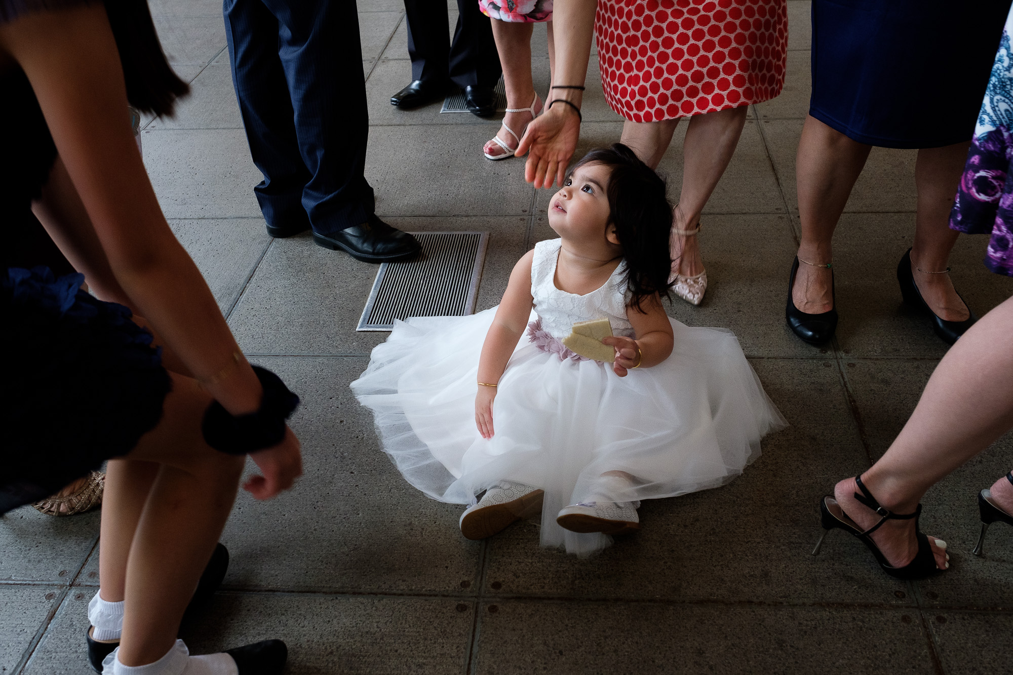  The flower girl enjoys the the crowd after the wedding ceremony at St Gabriel’s Parish in Toronto before leaving for the reception at the Argonaut Rowing Club on Toronto’s waterfront. 
