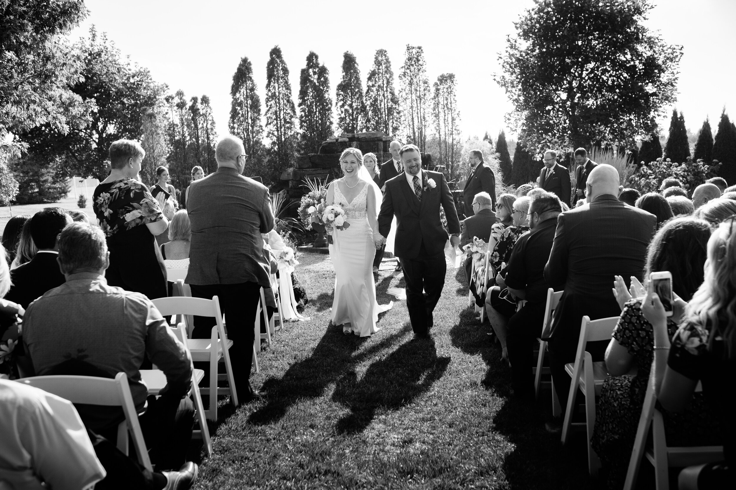  Amanda and Chad head back down the aisle after their outdoor wedding ceremony during their wedding at the Hessenland Inn by Ontario Wedding Photographer Scott Williams. 