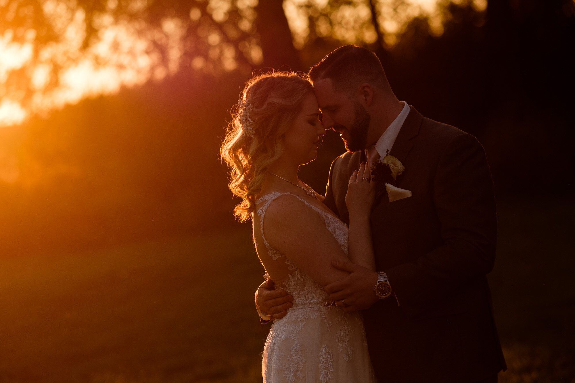  The bride and groom pose for some golden hour sunset wedding portraits at the Three Bridges event centre located outside of Waterloo, Ontario. Photograph by Toronto wedding photographer Scott Williams. 