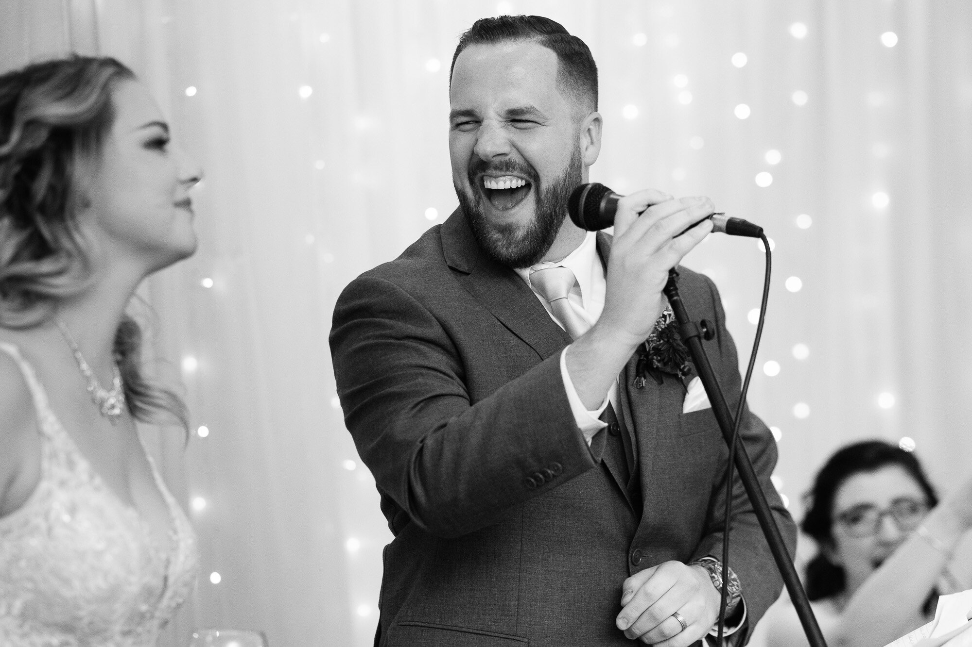  The groom has a laugh while giving his wedding speech during the reception at the Three Bridges event centre located outside of Waterloo, Ontario. Photograph by Toronto wedding photographer Scott Williams. 