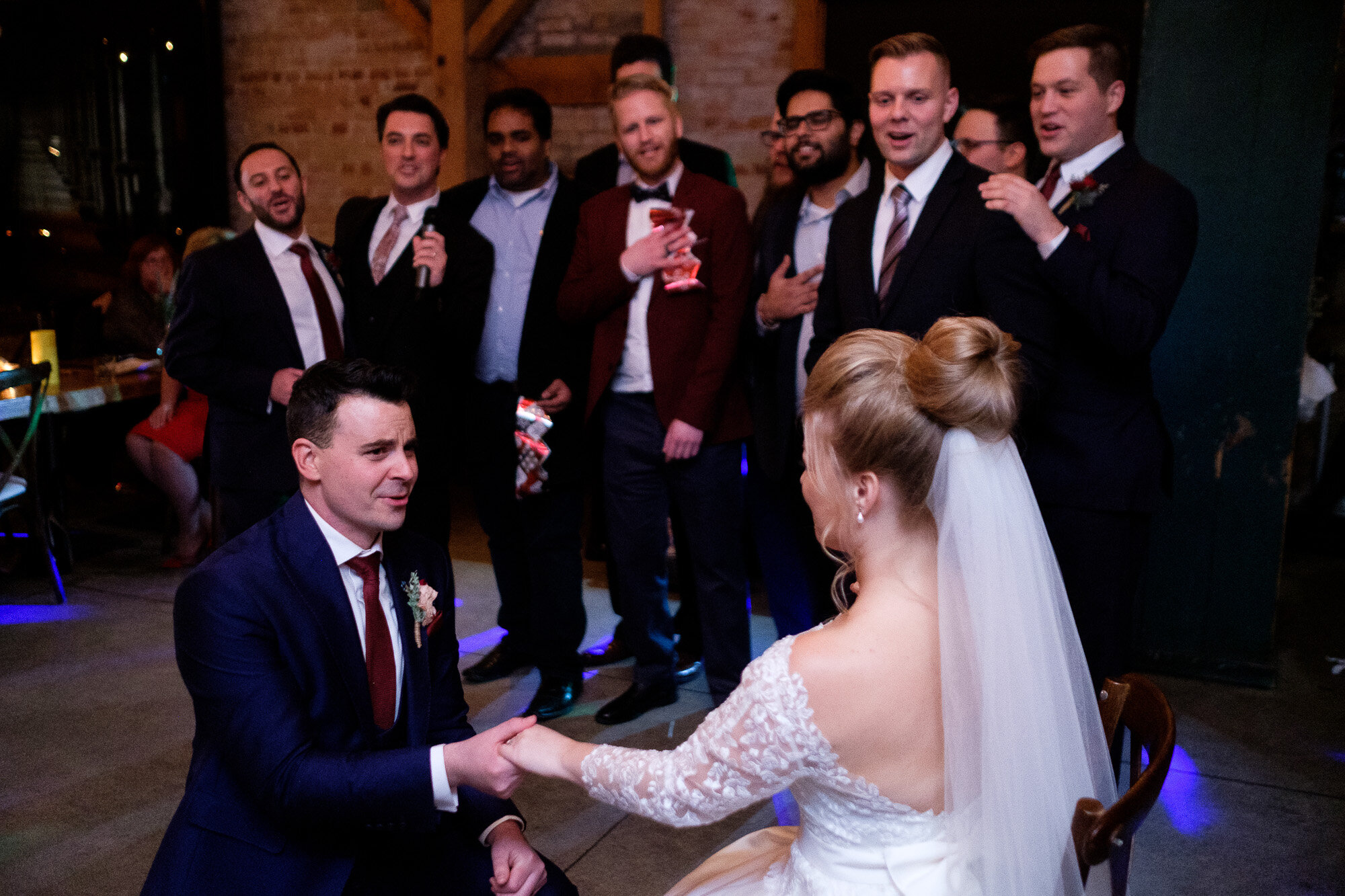  Emily  is serenaded by Aaron’s fraternity brothers during  their wedding at Archeo in Toronto’s Distillery district by Toronto Wedding Photographer Scott Williams. 