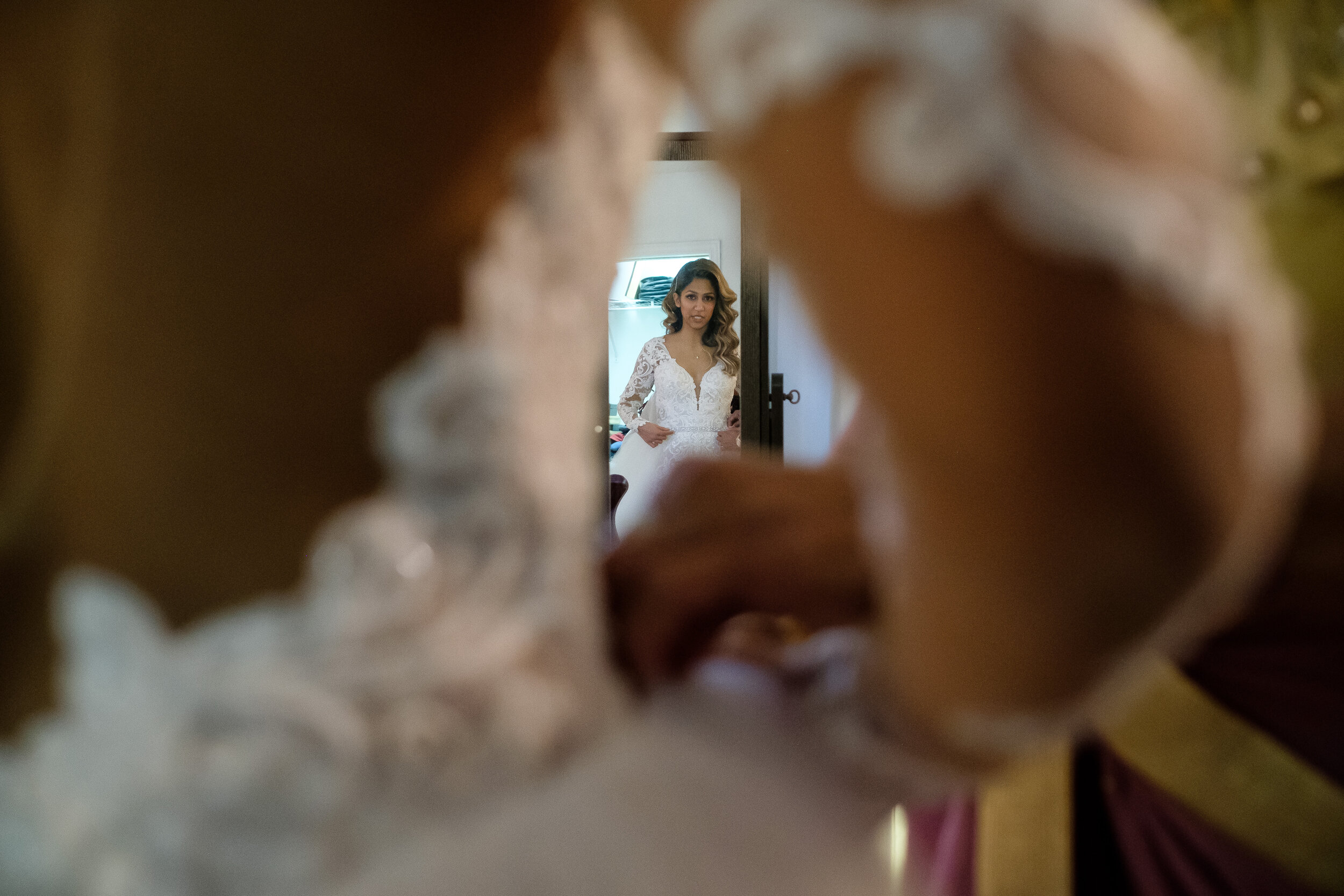  Anita looks over the last details on her dress before Anita &amp; Gehan’s winter wedding at Angus Glenn just outside of Toronto, Ontario. Wedding photograph by Scott Williams (www.scottwilliamsphotographer.com) 