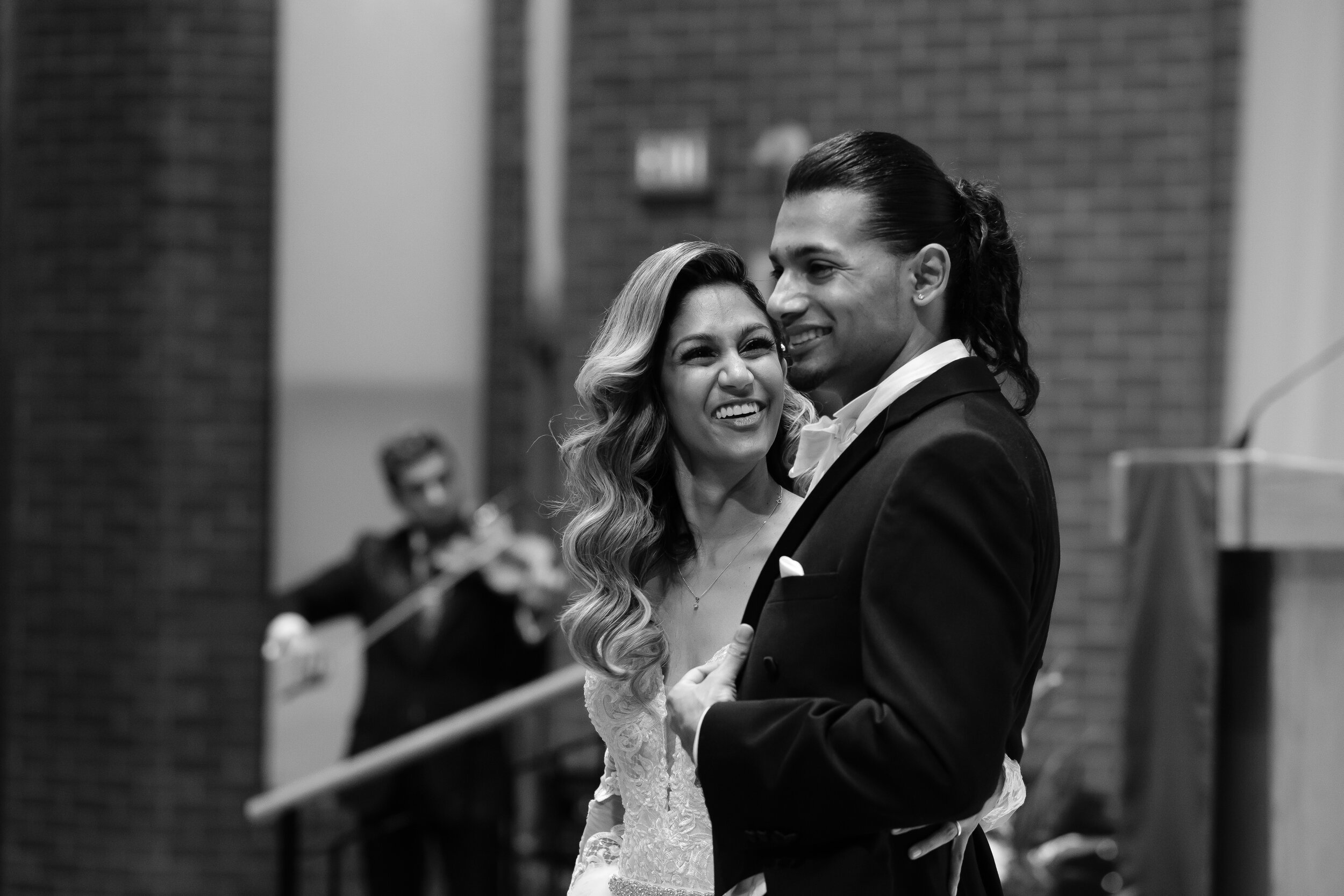  Anita + Gehan share a laugh during their wedding ceremony before  Anita &amp; Gehan’s winter wedding reception at Angus Glenn just outside of Toronto, Ontario. Wedding photograph by Scott Williams (www.scottwilliamsphotographer.com) 