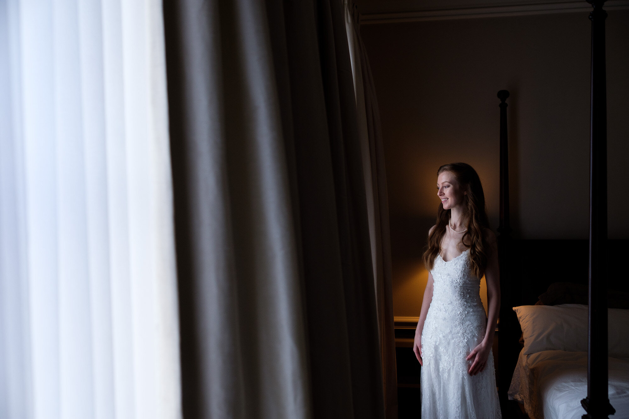  Laura poses for a wedding portrait in her room at Langdon Hall in Cambridge, Ontario during their small intimate winter wedding. Wedding photograph by Toronto wedding photographer Scott Williams. 