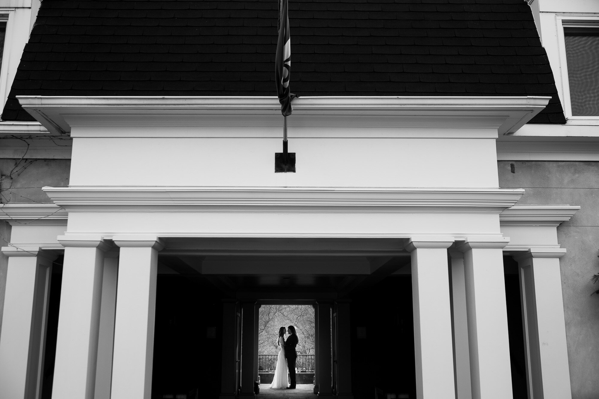  Laura + Raymond pose for a wedding portrait on the grounds of Langdon Hall in Cambridge, Ontario during their small intimate winter wedding. Wedding photograph by Toronto wedding photographer Scott Williams. 