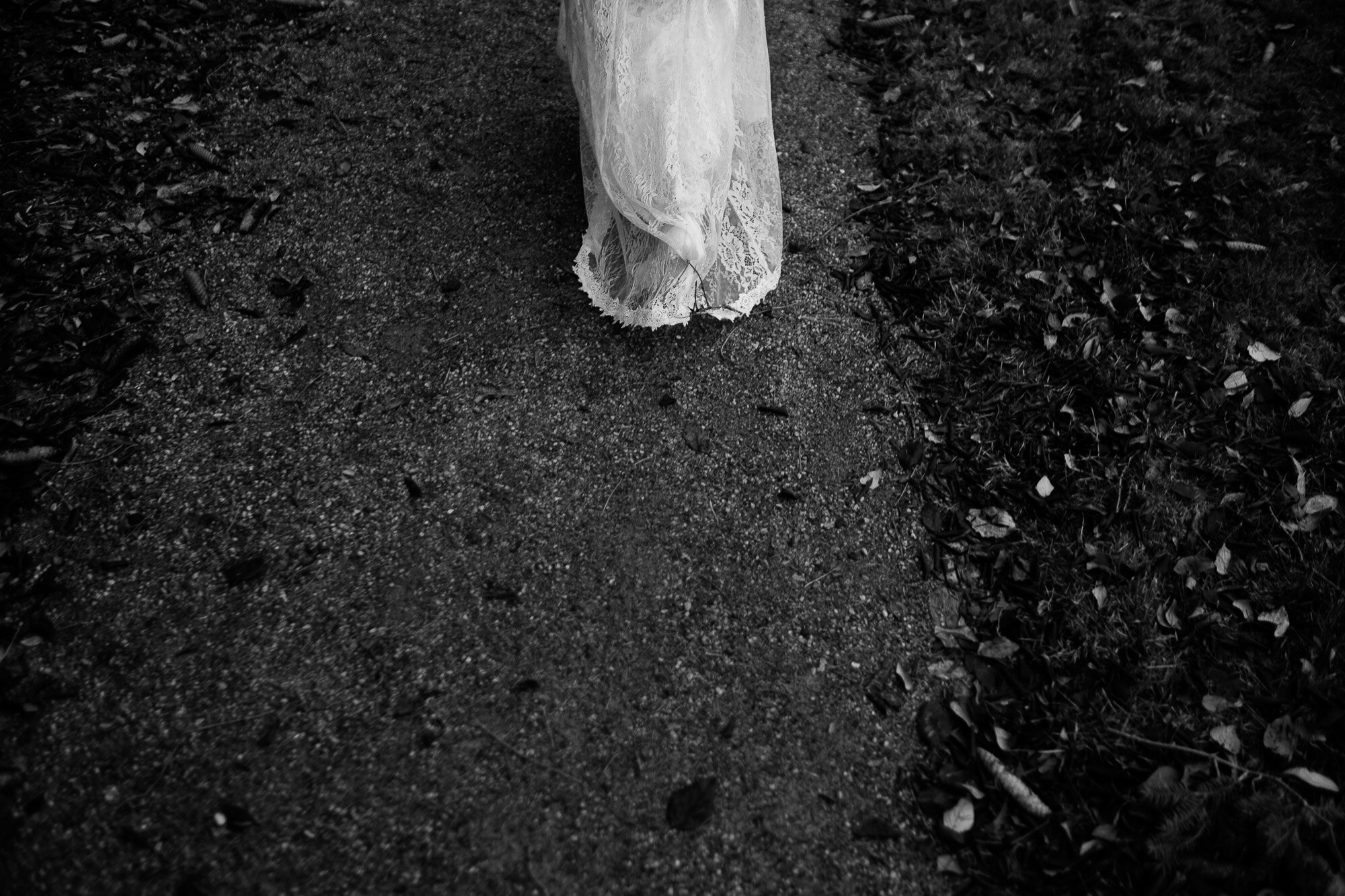  A photograph of the brides dress as she walks across the grounds of Langdon Hall in Cambridge, Ontario during their small intimate winter wedding. Wedding photograph by Toronto wedding photographer Scott Williams. 